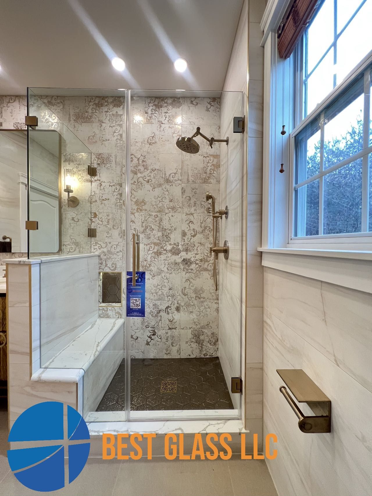A bathroom with a walk in shower and a window.