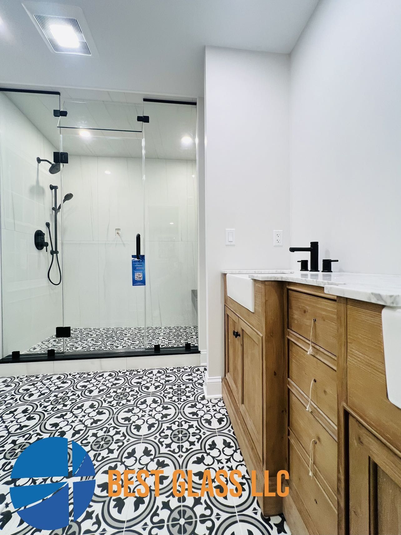 A bathroom with a walk in shower and a sink.