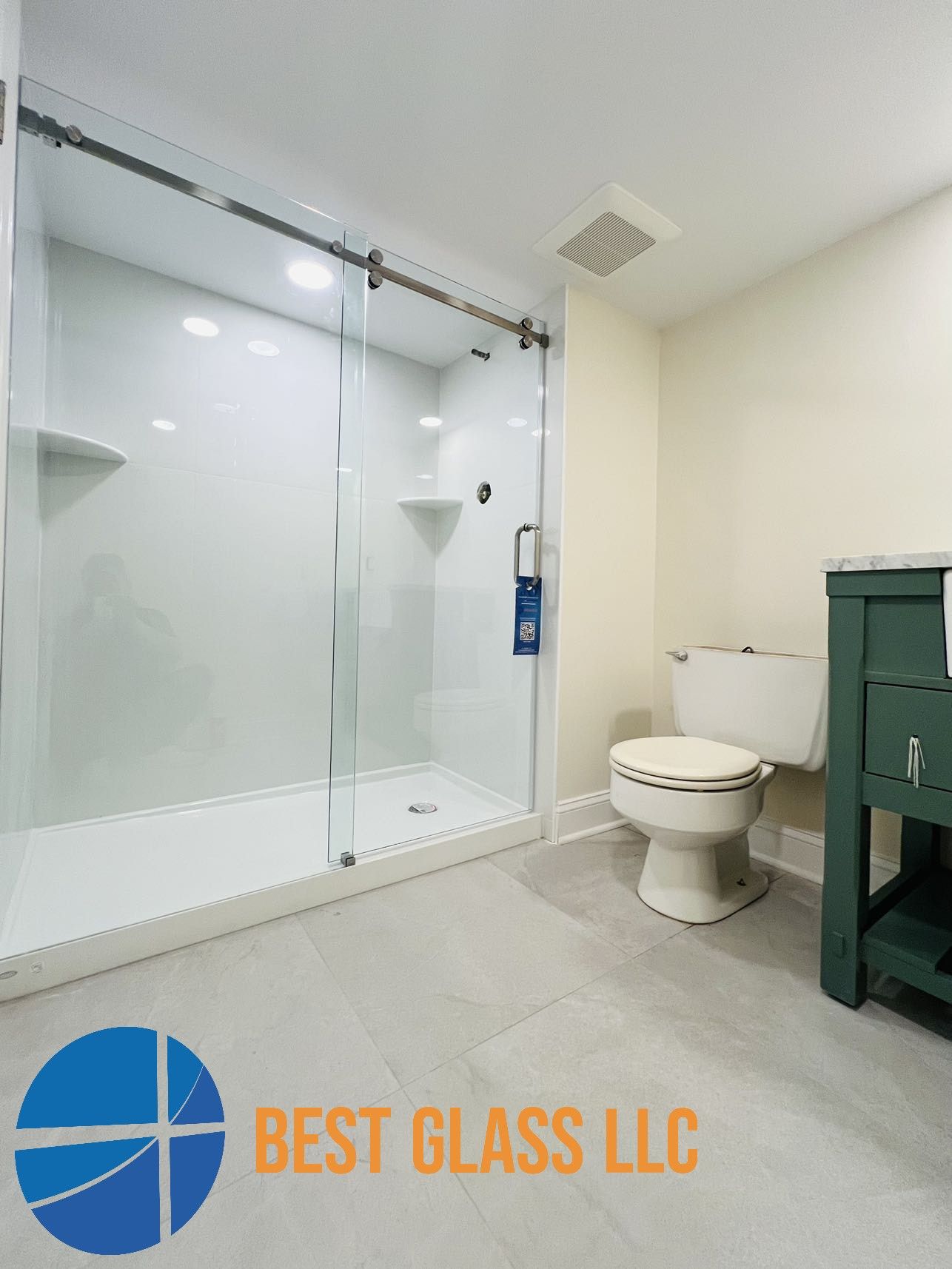 A bathroom with a toilet , shower , and sink.