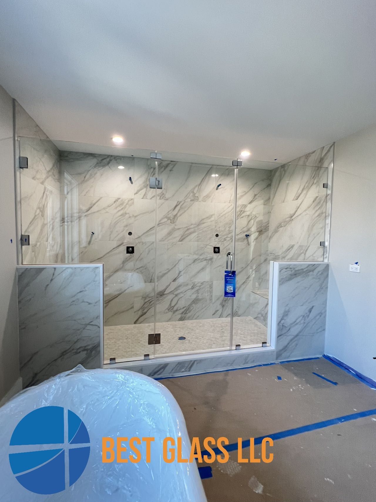 A bathroom with a walk in shower and a bathtub.