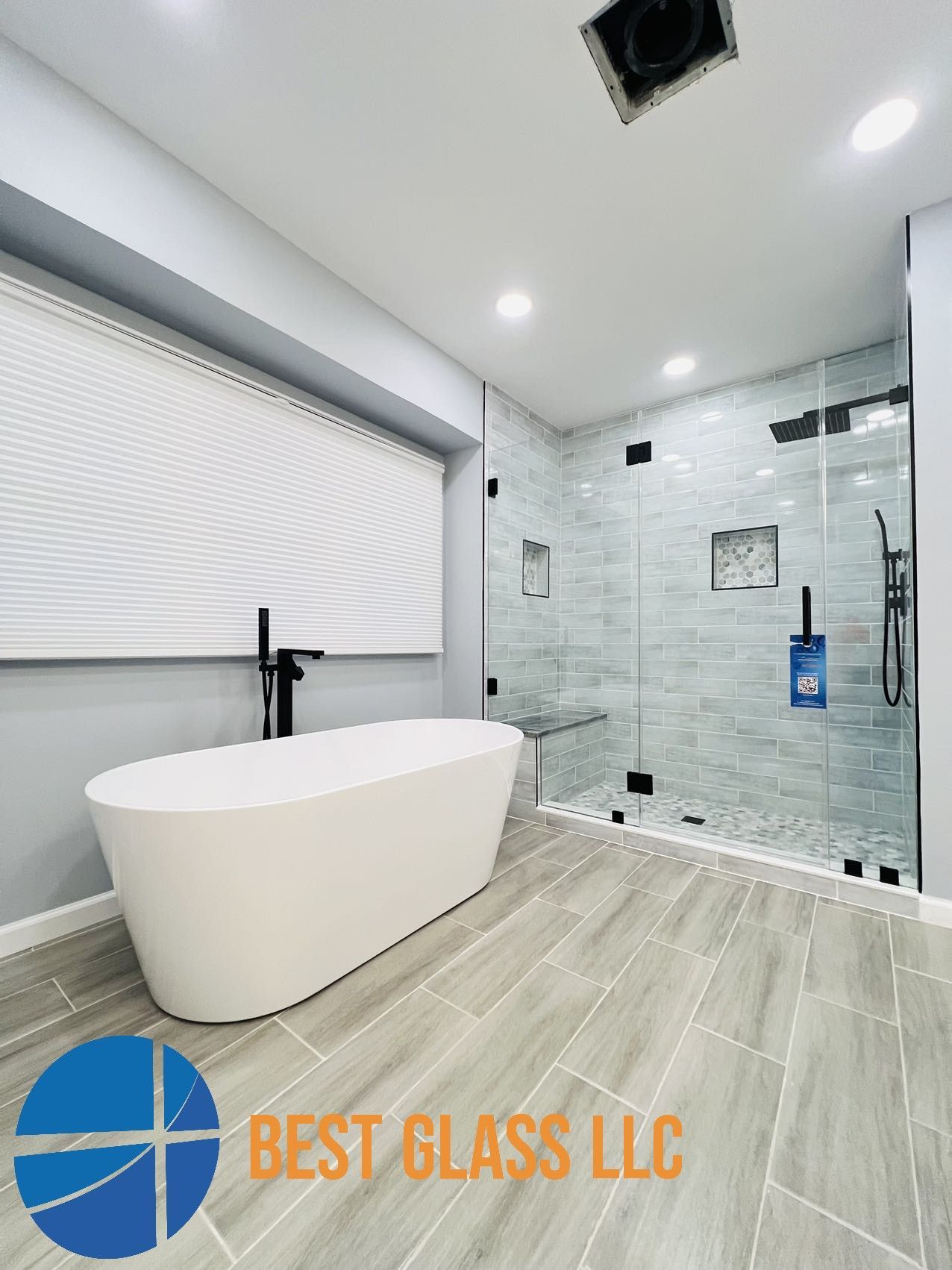 A bathroom with a bathtub and a walk in shower.