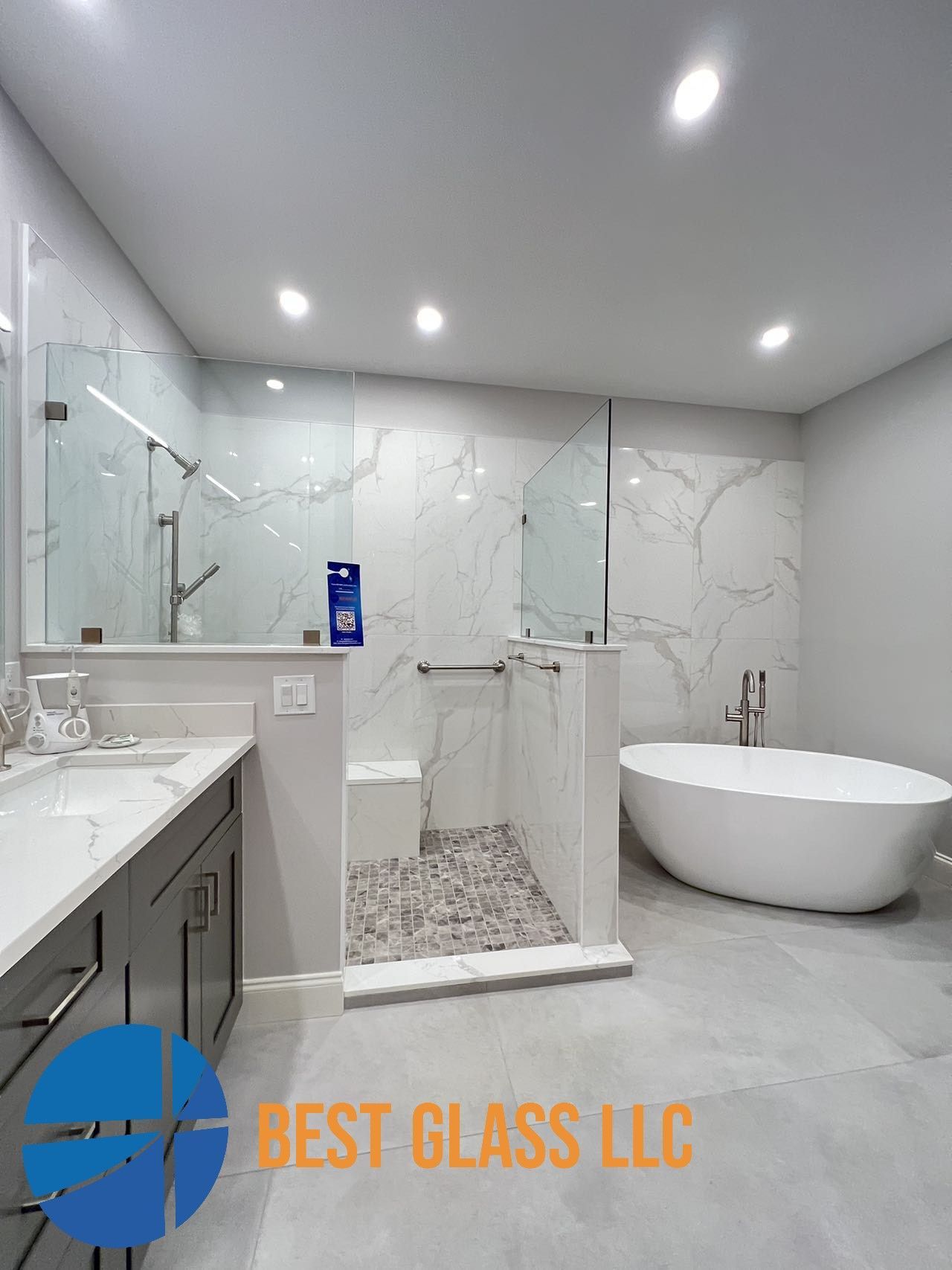 A bathroom with a bathtub , sink , shower and walk in shower.