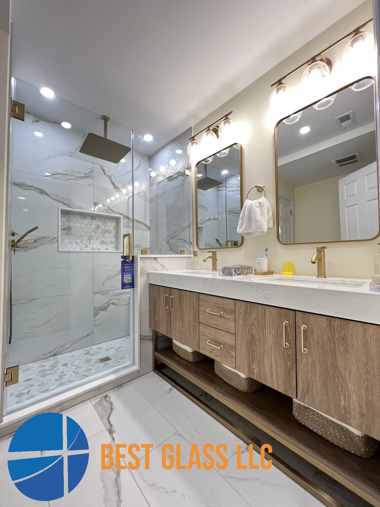 A bathroom with a walk in shower and two sinks