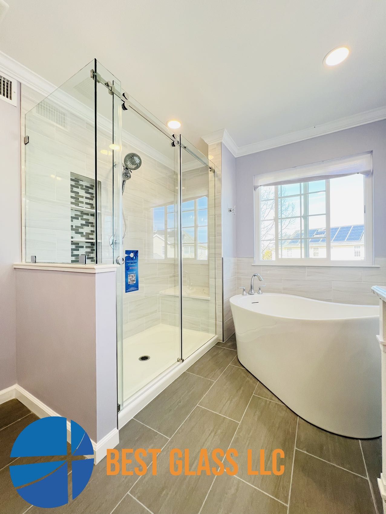 A bathroom with a tub , shower , and window.