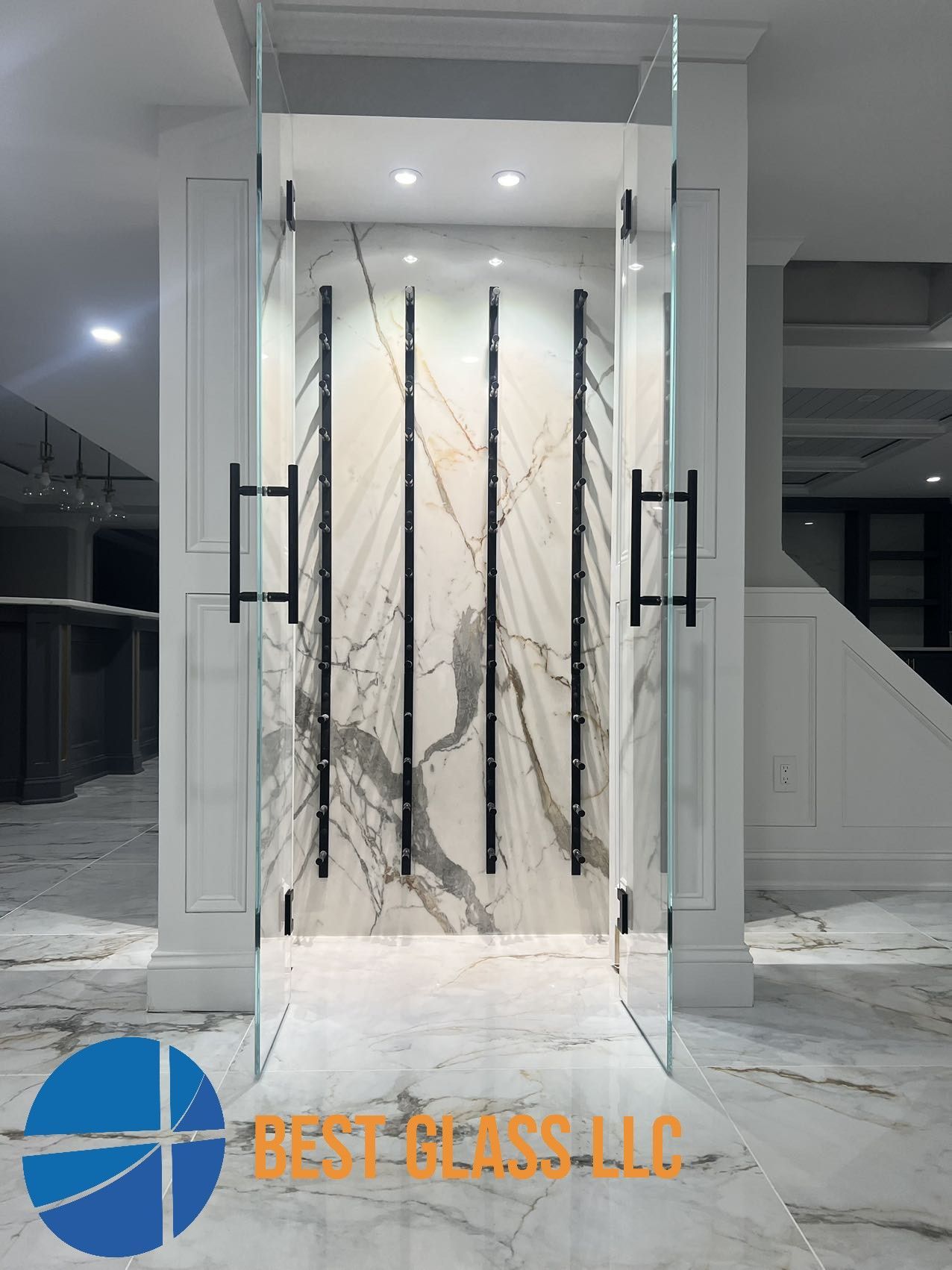 A room with a marble wall and a glass door.