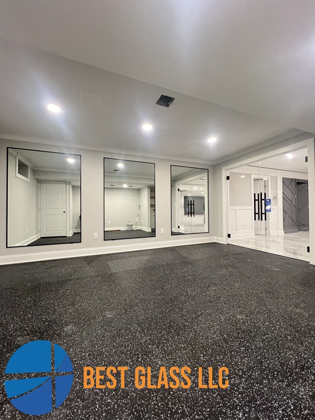 A large empty room with a lot of mirrors on the wall.