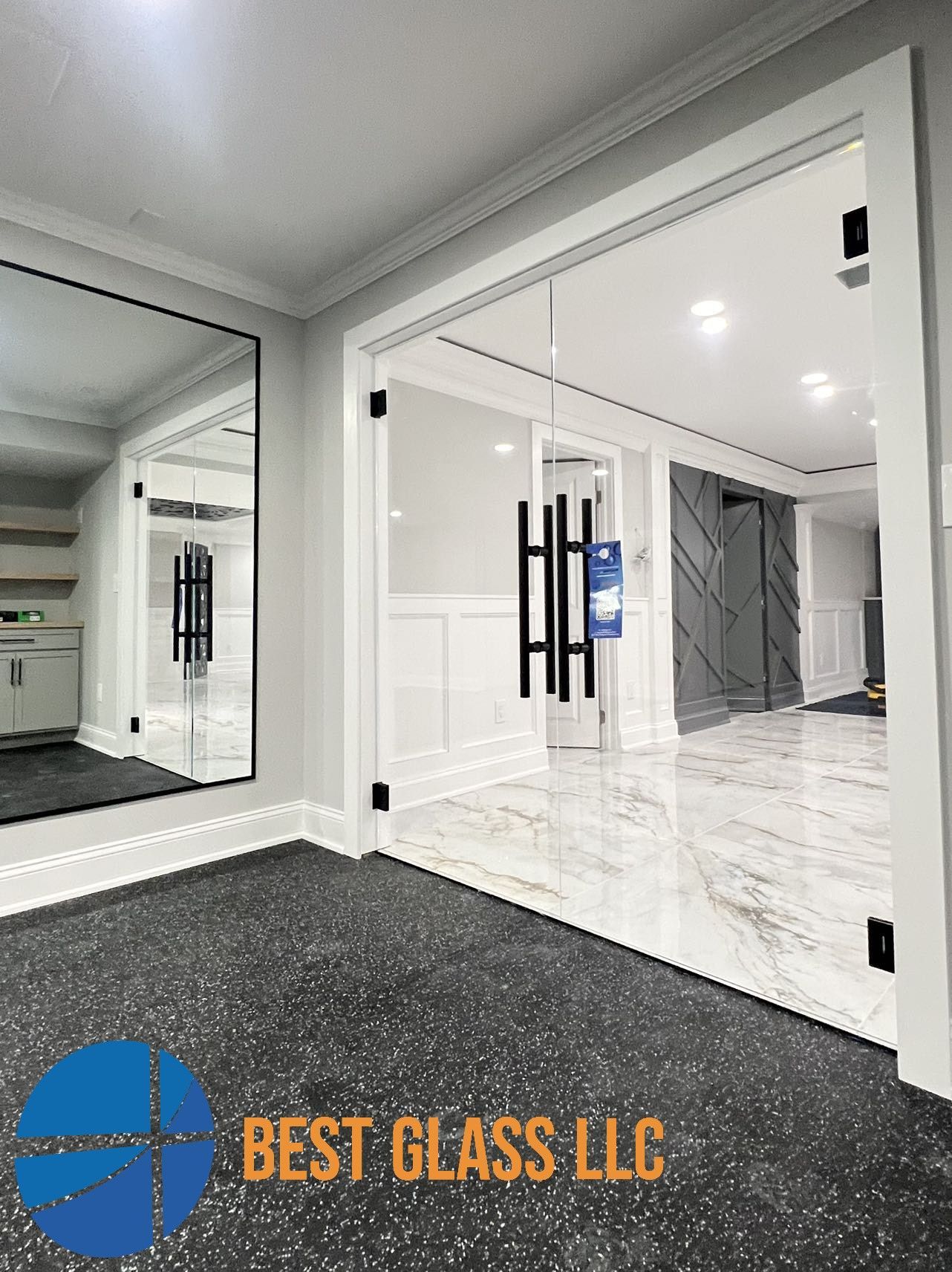 A basement with sliding glass doors and a large mirror.