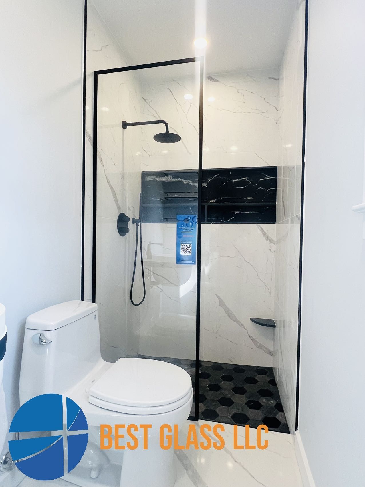 A bathroom with a toilet and a walk in shower.