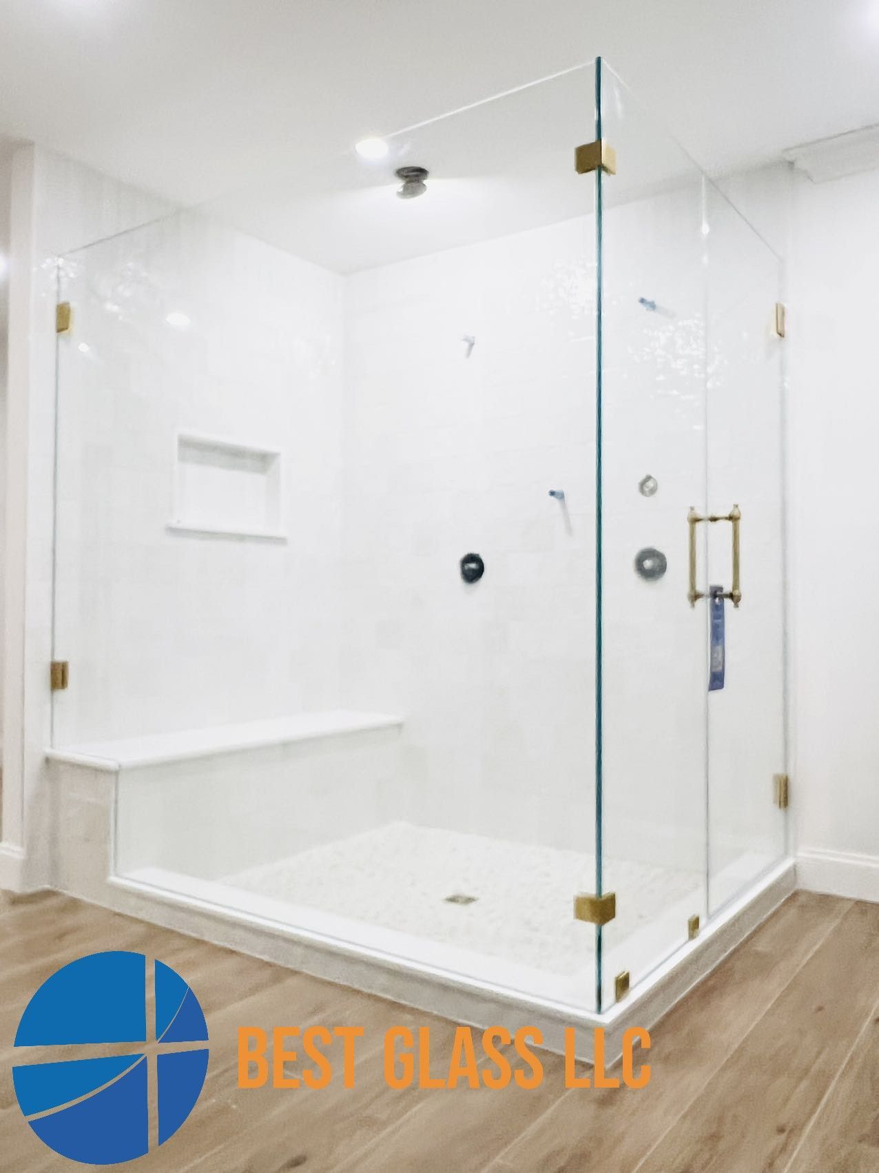 A bathroom with a walk in shower and a bench.