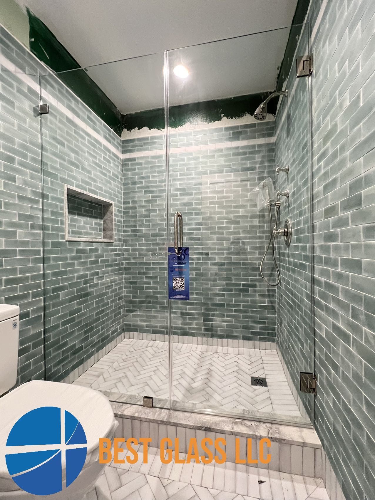 A bathroom with a walk in shower and a toilet.