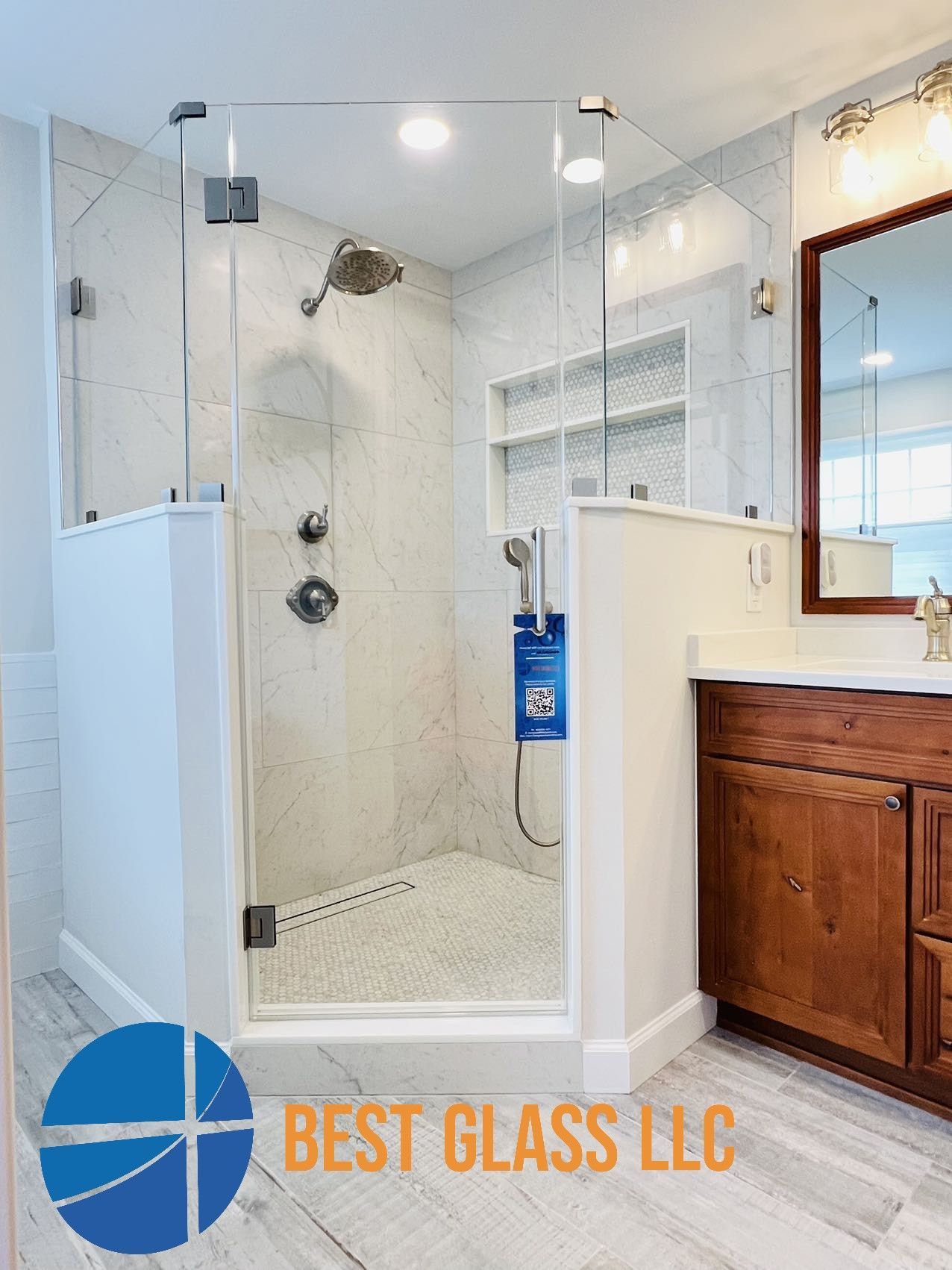 A bathroom with a walk in shower and a sink.