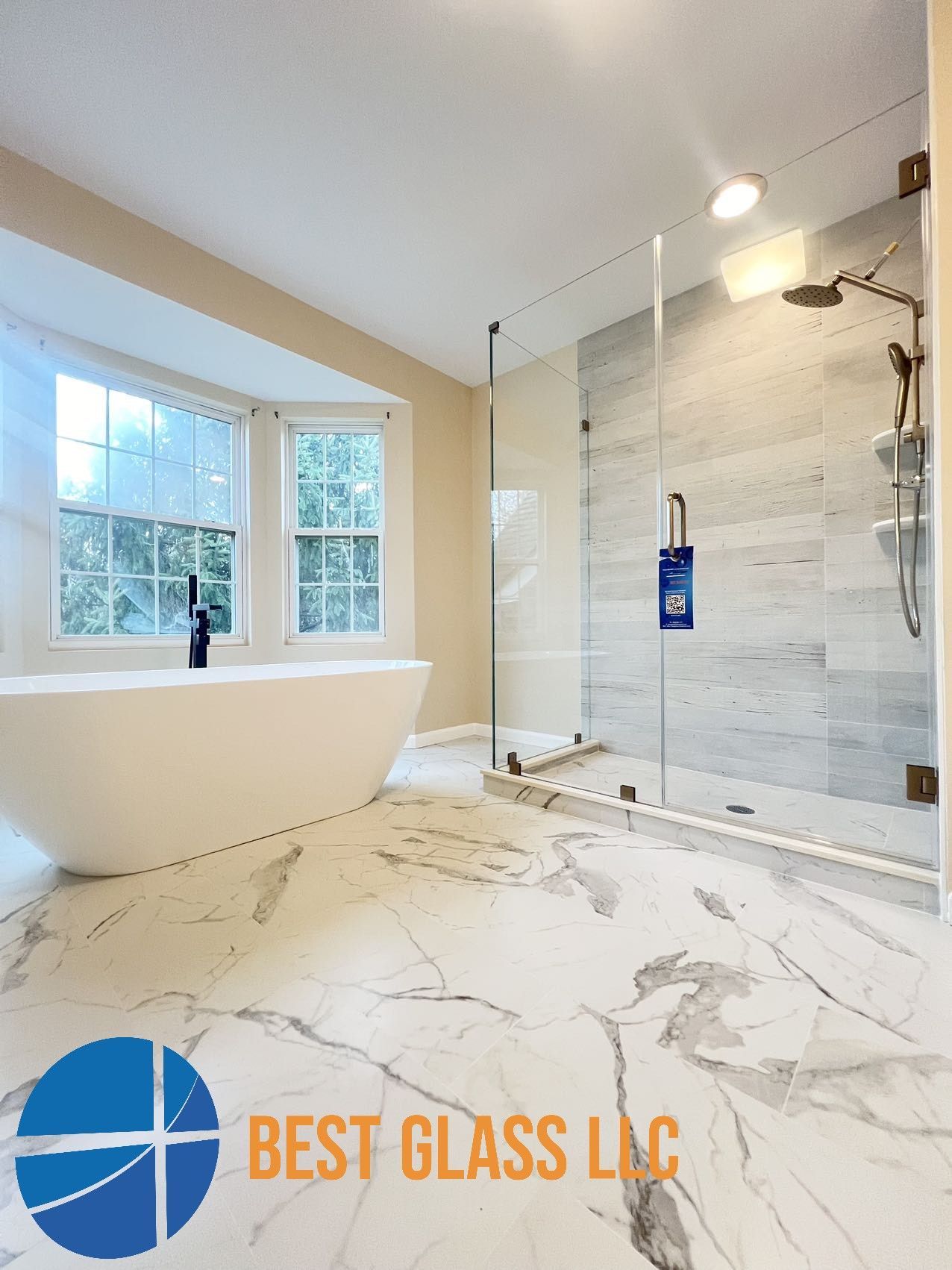 A bathroom with a bathtub and a walk in shower.