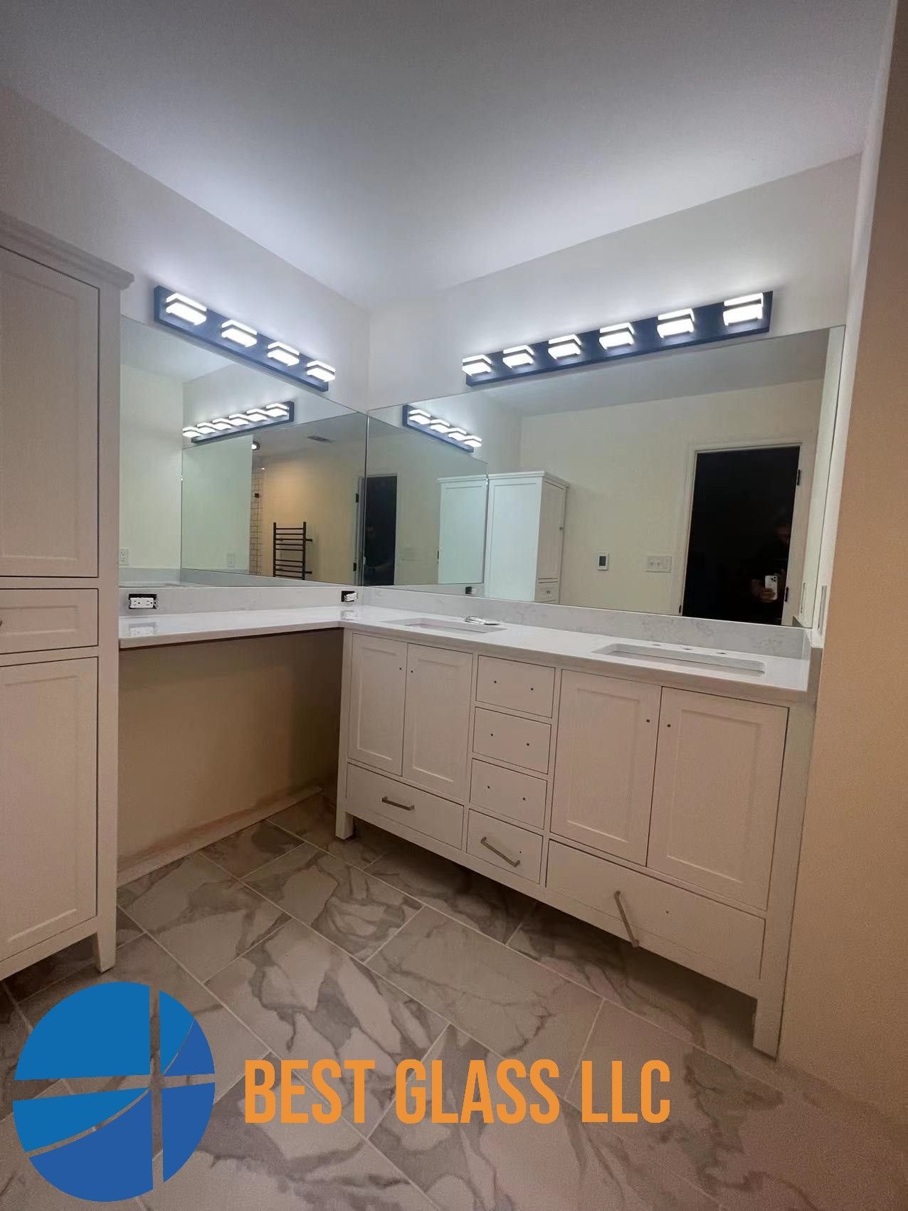 A bathroom with two sinks and a large mirror.