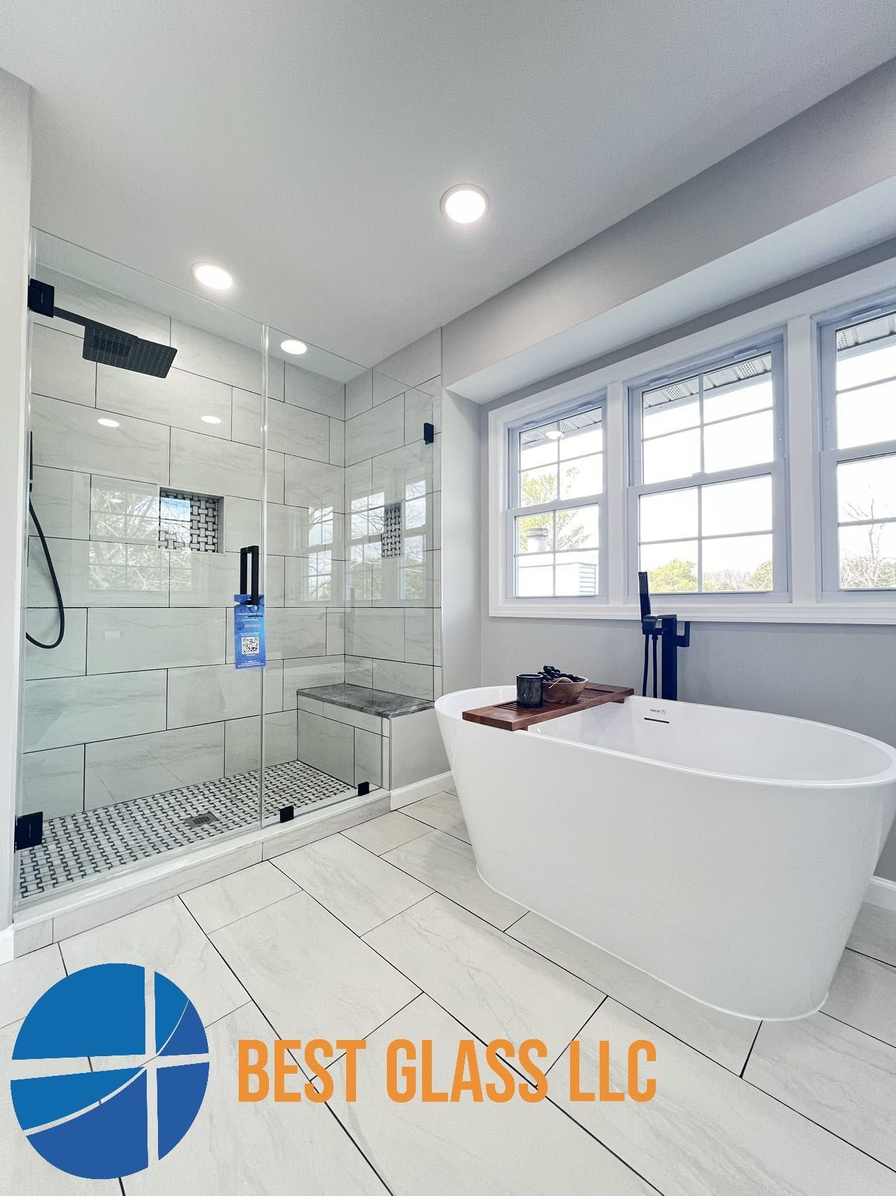 A bathroom with a tub , shower , and window.