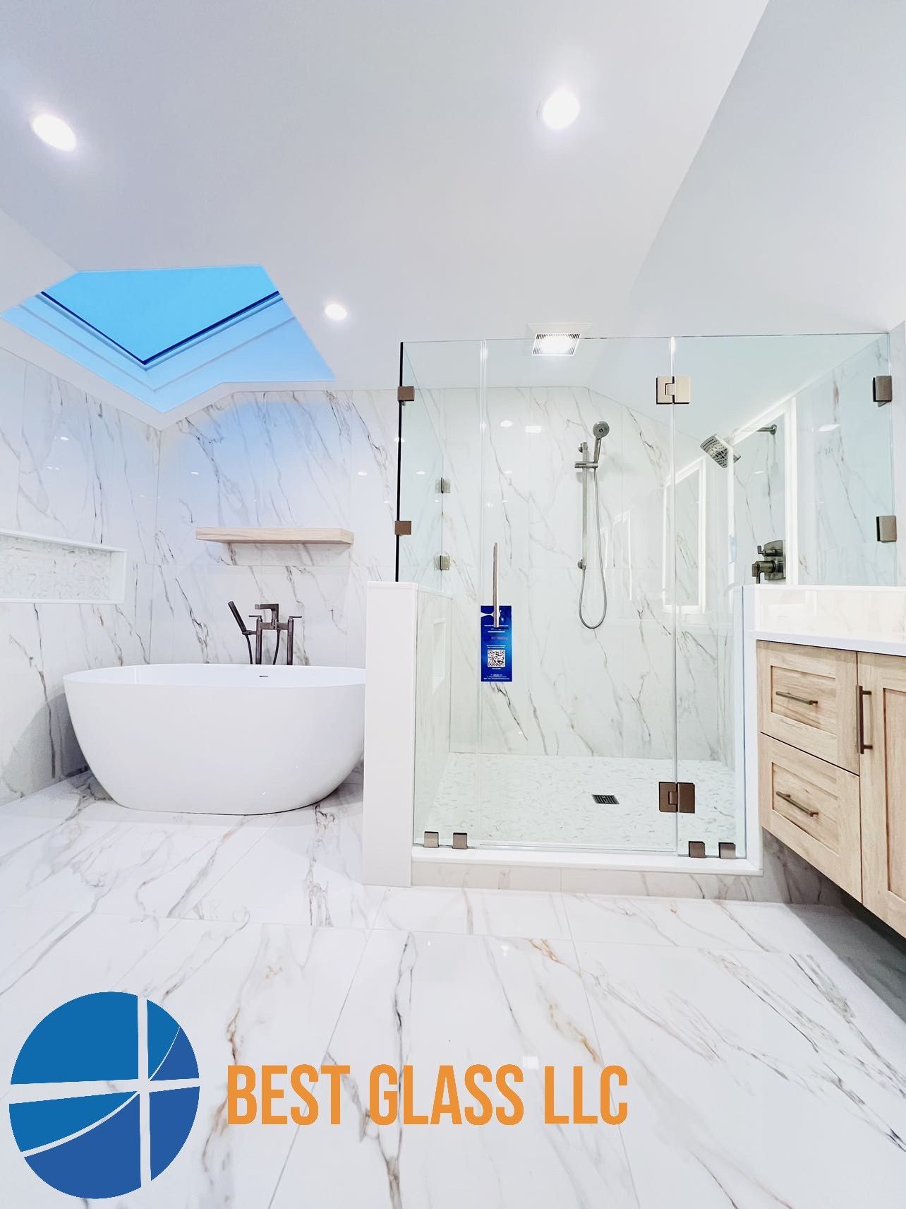 A bathroom with a bathtub , shower , sink and skylight.