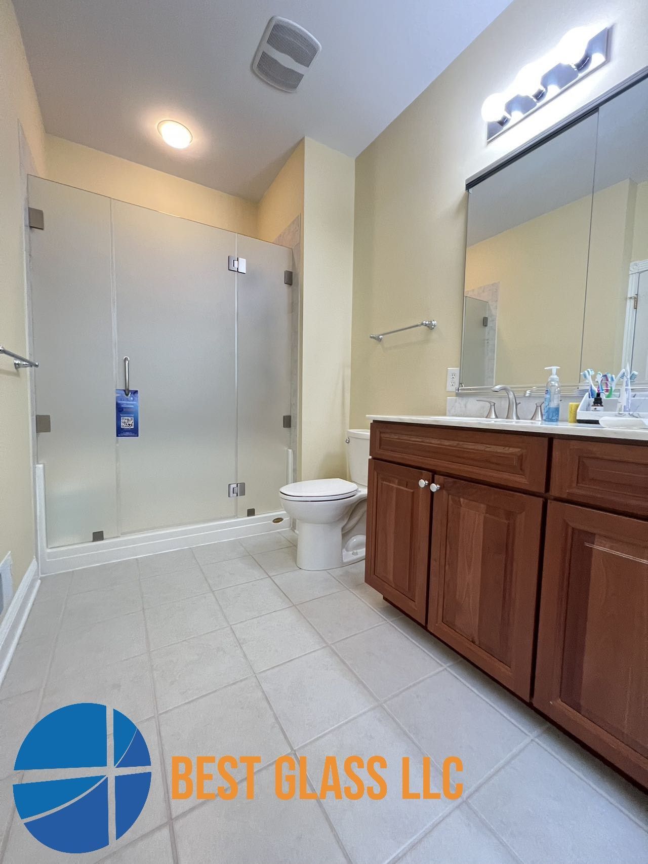A bathroom with a toilet , sink , and shower stall.