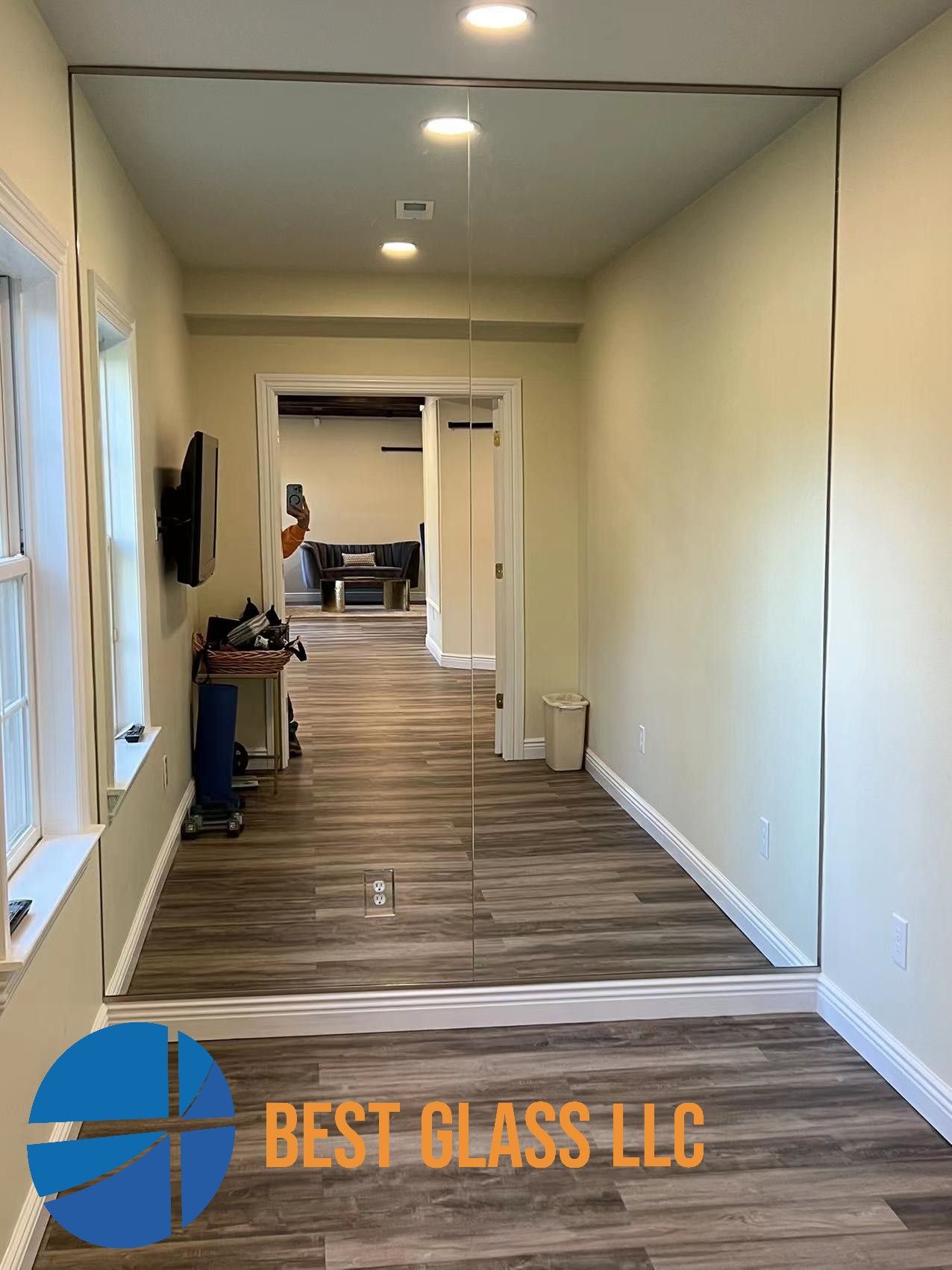 A hallway with a large mirror on the wall.