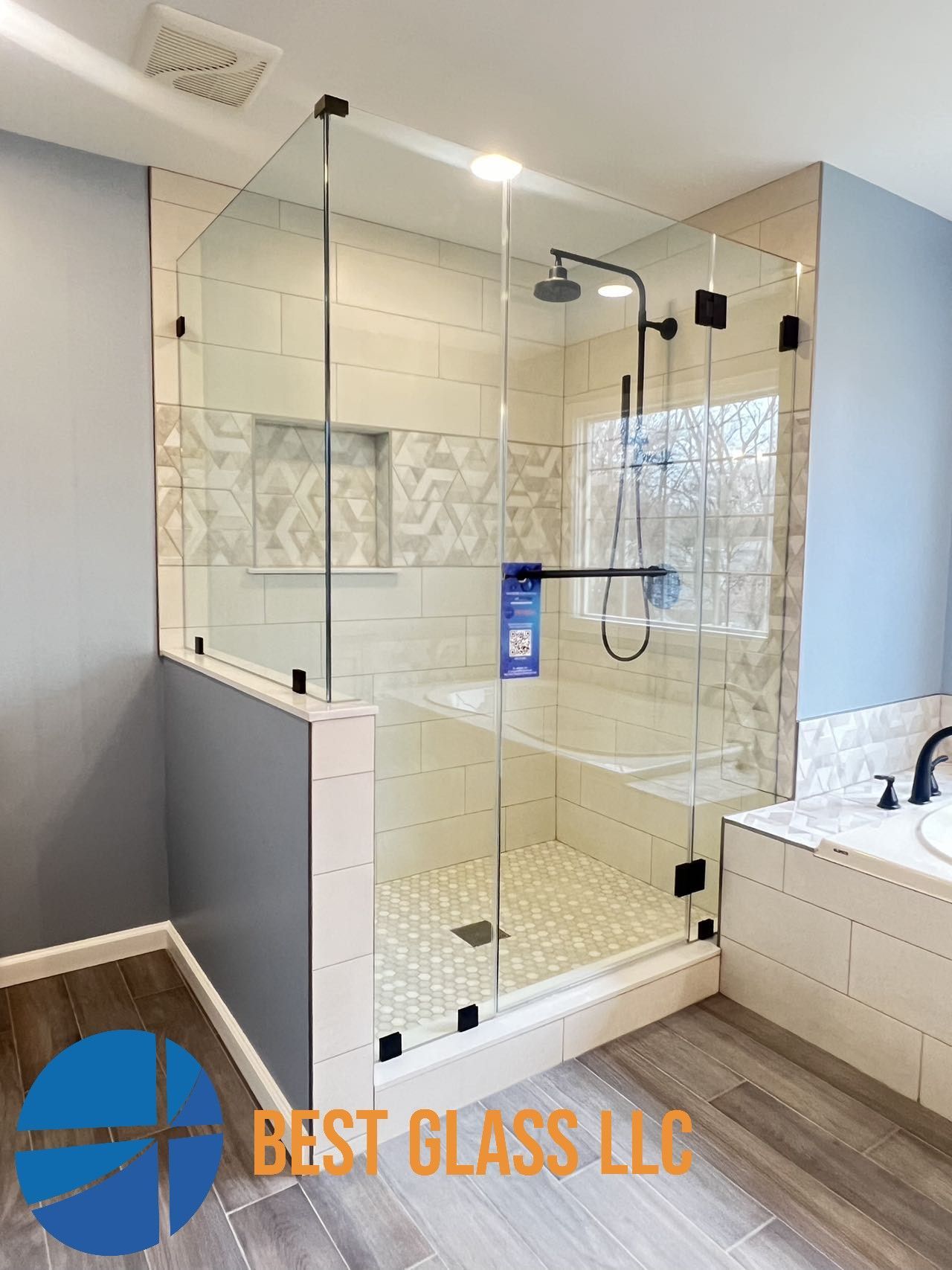 A bathroom with a walk in shower and a bathtub.