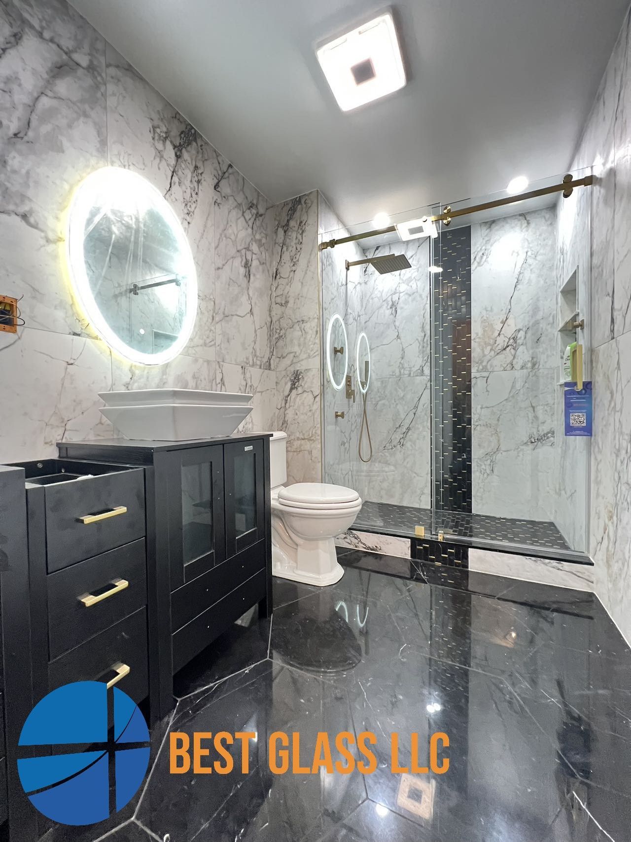 A bathroom with a sink , toilet , shower and mirror.