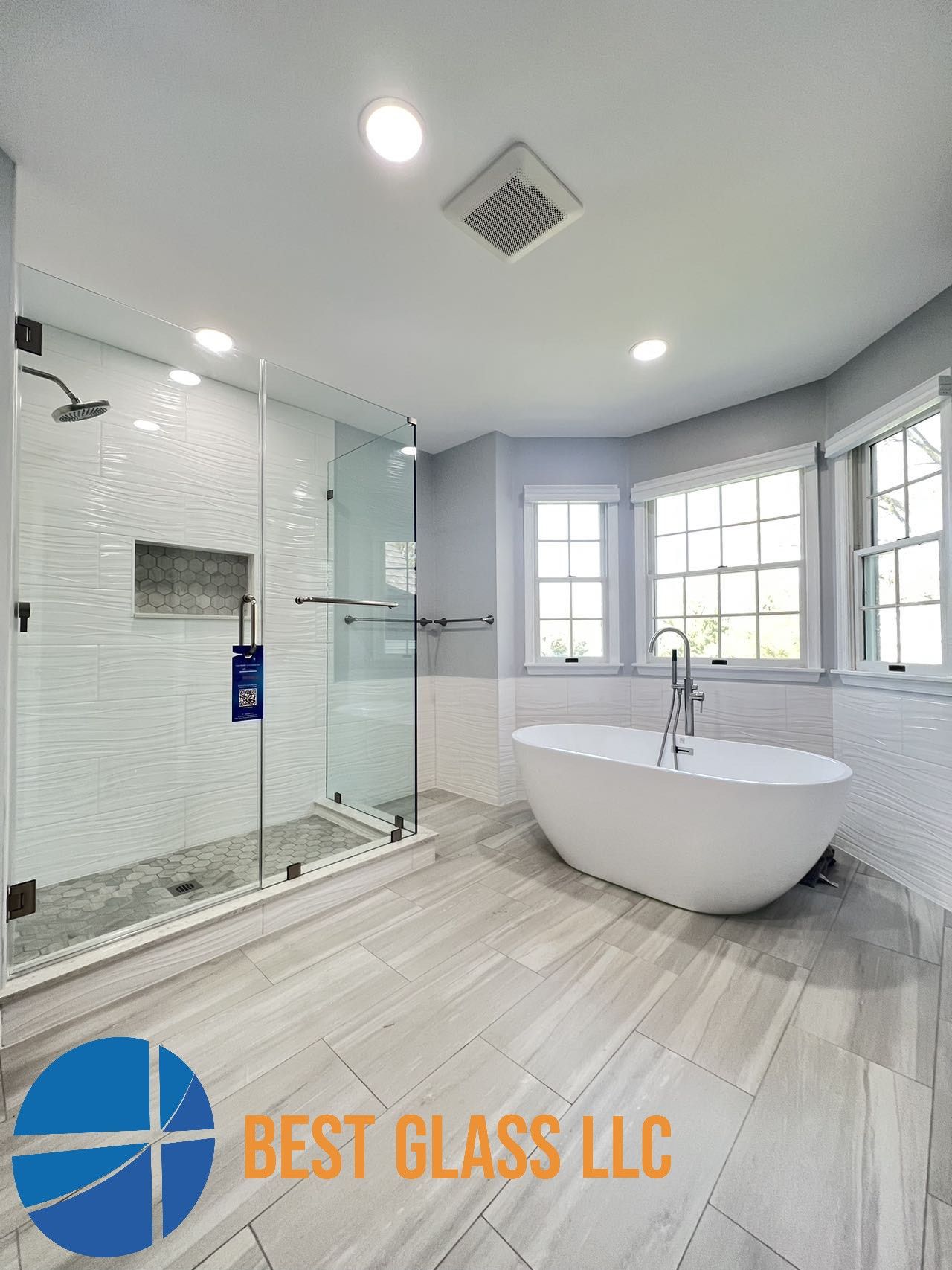 A bathroom with a tub , shower , and window.