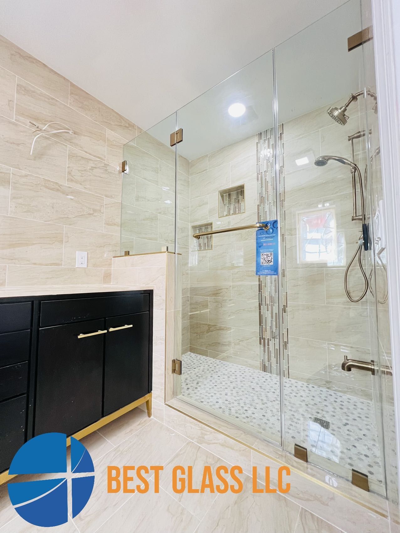 A bathroom with a walk in shower and a vanity.