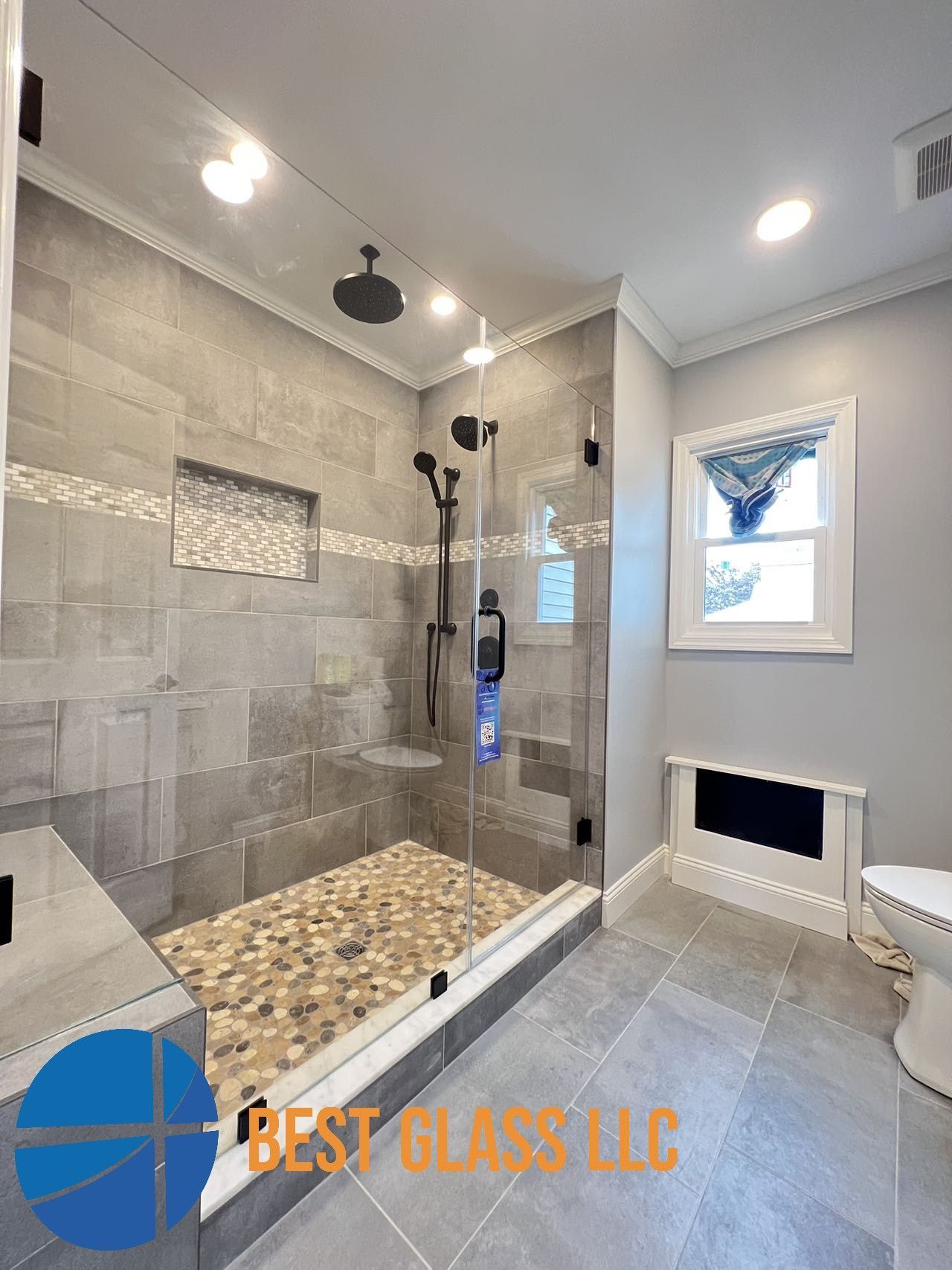 A bathroom with a walk in shower and a toilet.