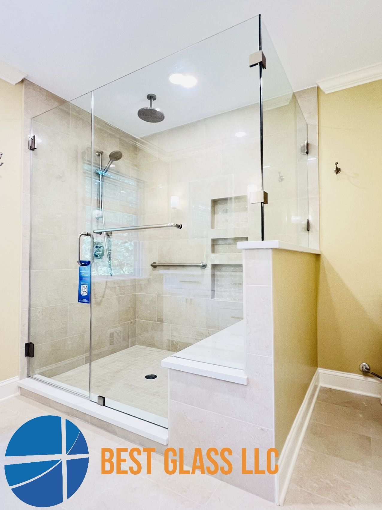 A bathroom with a walk in shower with a glass door.