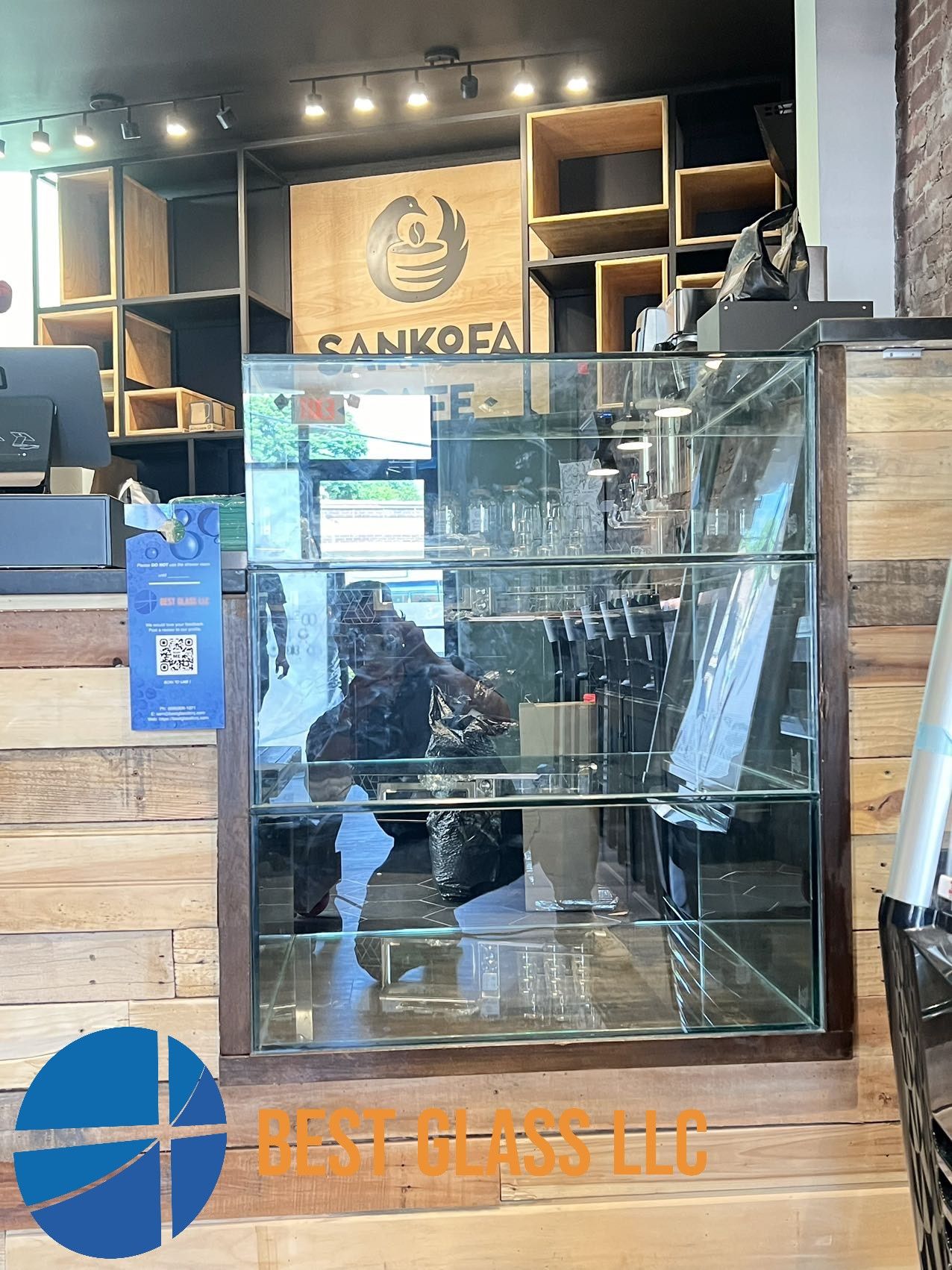 A glass display case is sitting on a wooden counter in a store.