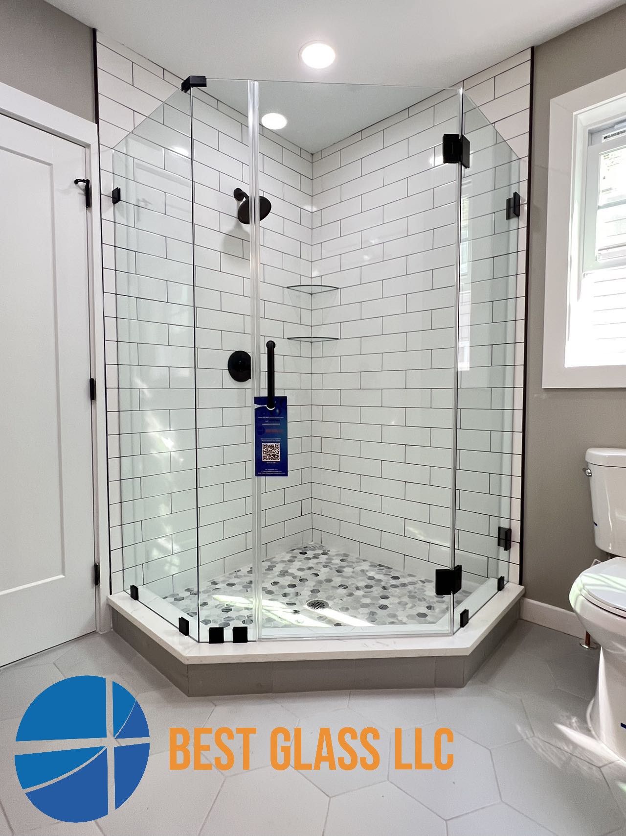 A bathroom with a shower stall and a toilet.