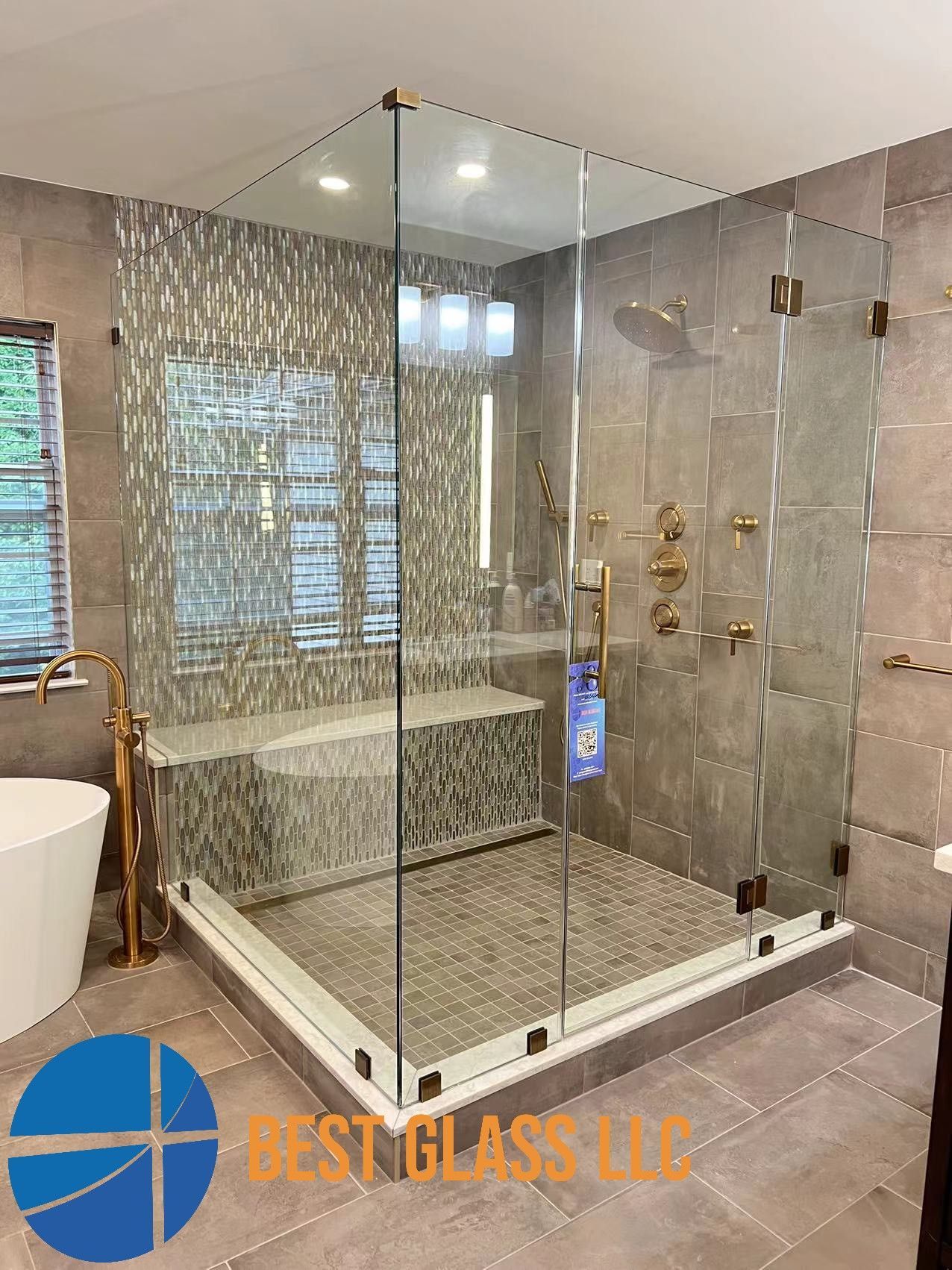 A bathroom with a walk in shower and a bathtub.