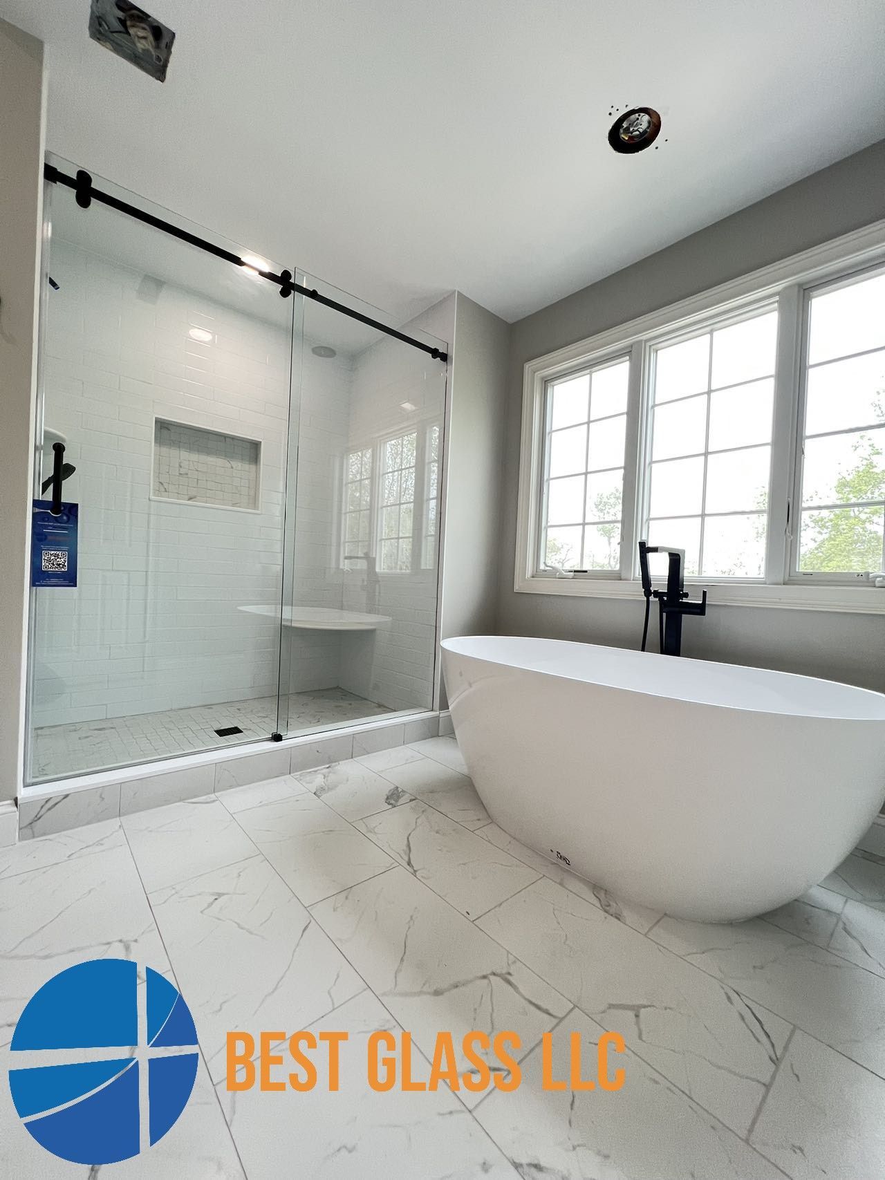 A bathroom with a tub , shower and window.