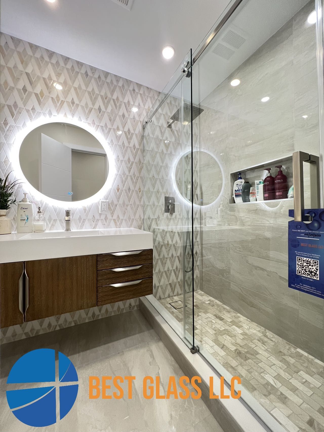 A bathroom with a sink , shower , and mirror.