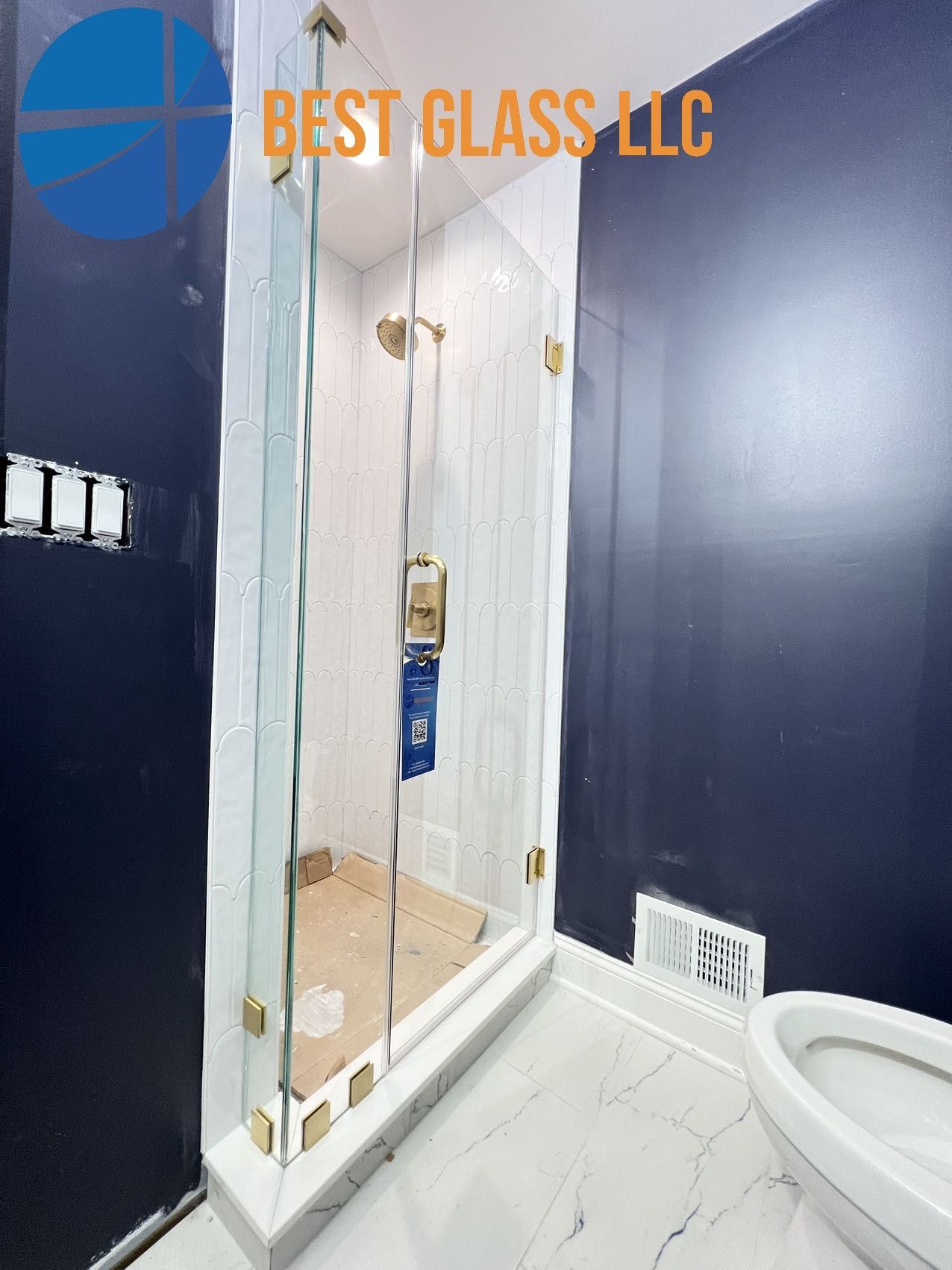 A bathroom with a walk in shower and a toilet.