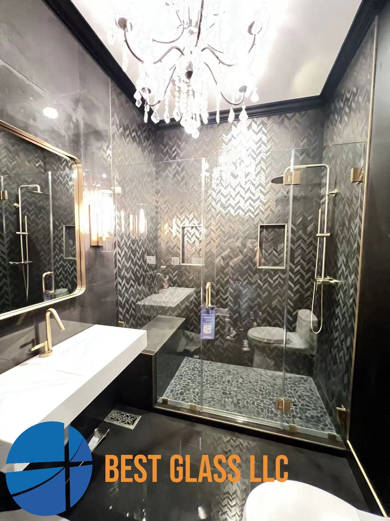 A bathroom with a walk in shower , sink , toilet and mirror.