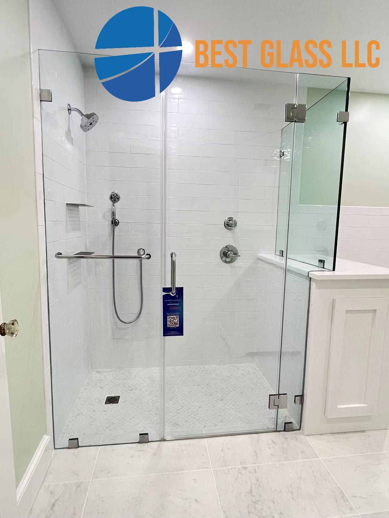 A bathroom with a shower and a sign that says best glass llc