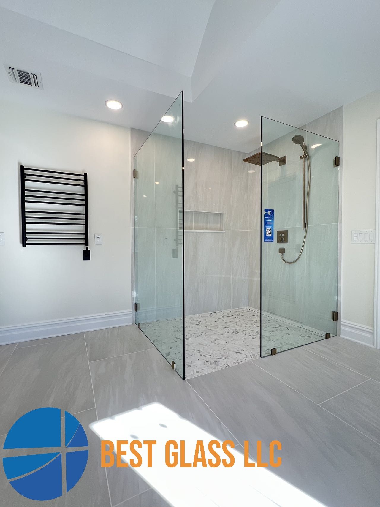 A bathroom with a walk in shower and a towel rack.