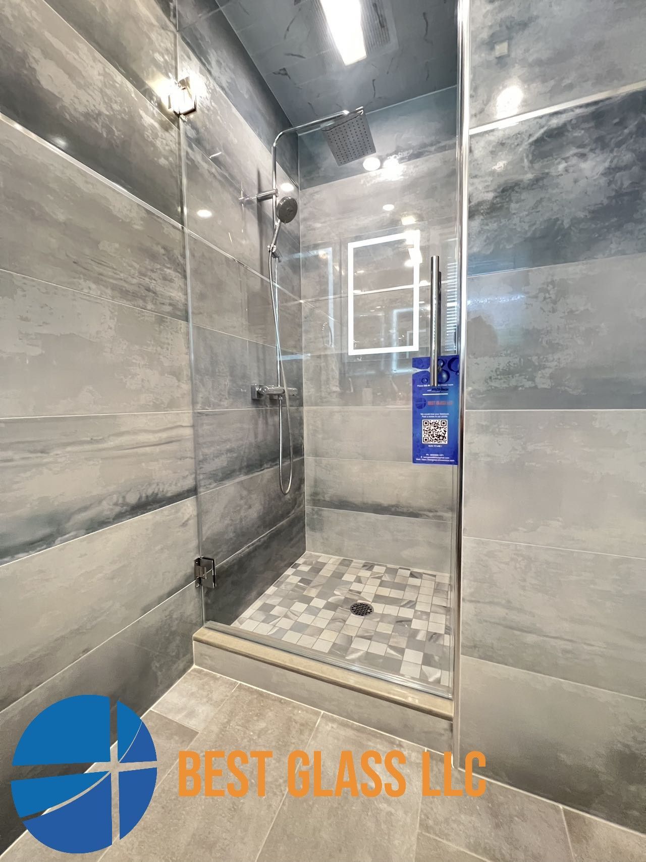 A bathroom with a walk in shower and tiled walls.