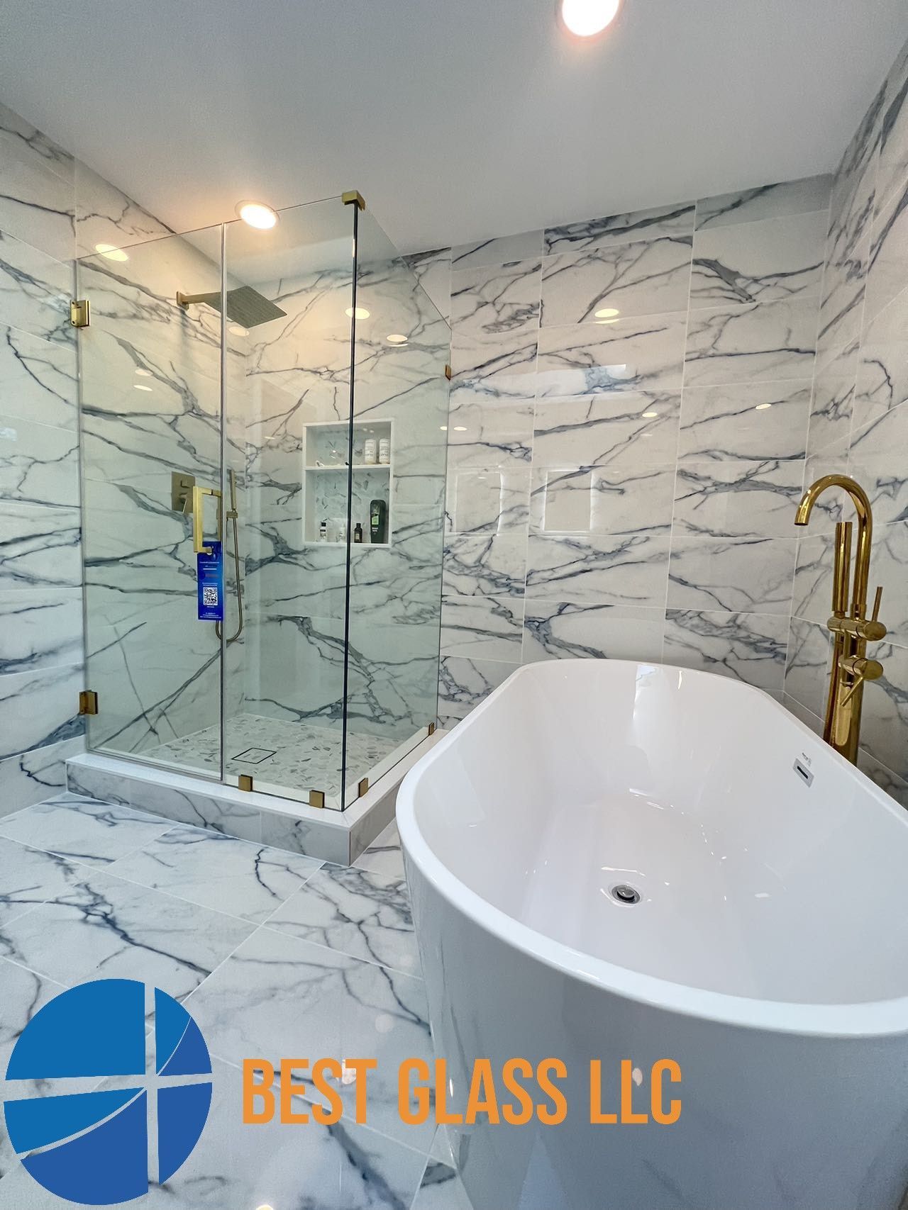 A bathroom with marble tiles and a bathtub and shower.
