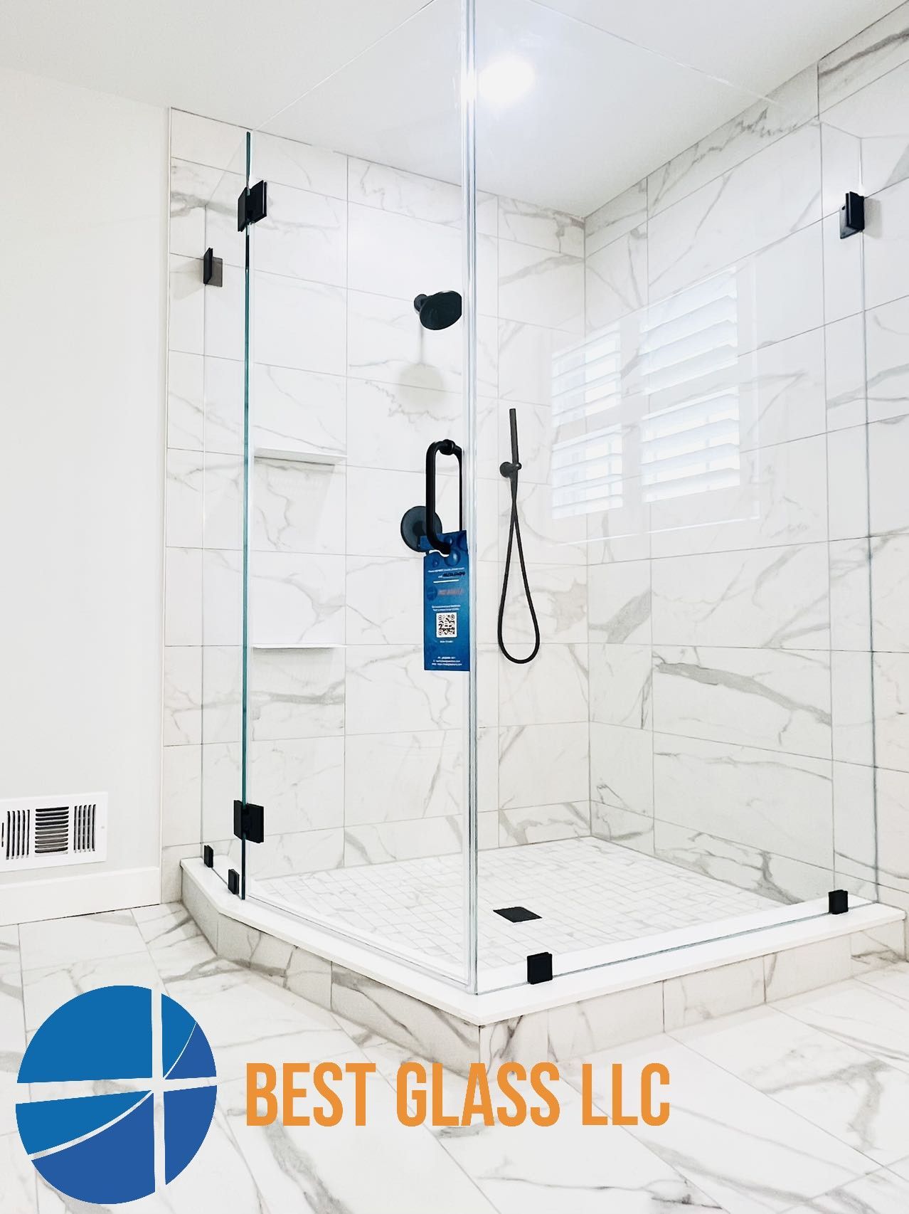 A bathroom with a walk in shower and a sign that says best glass llc