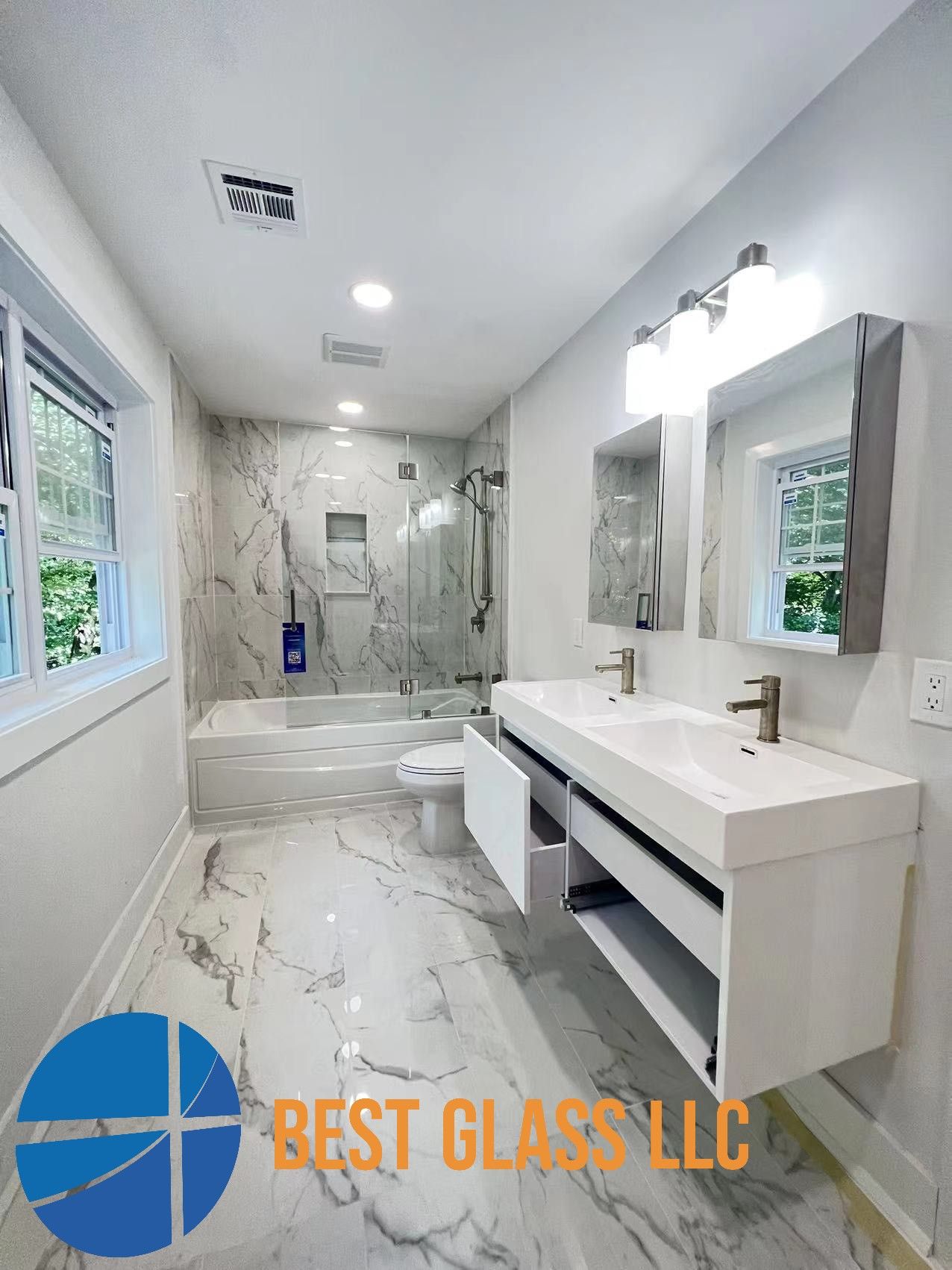 A bathroom with two sinks , a toilet , and a bathtub.