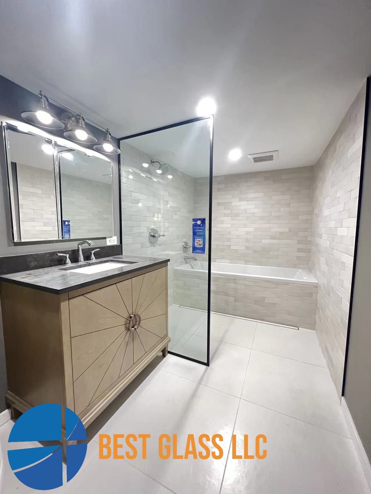 A bathroom with a walk in shower , sink , mirror and bathtub.