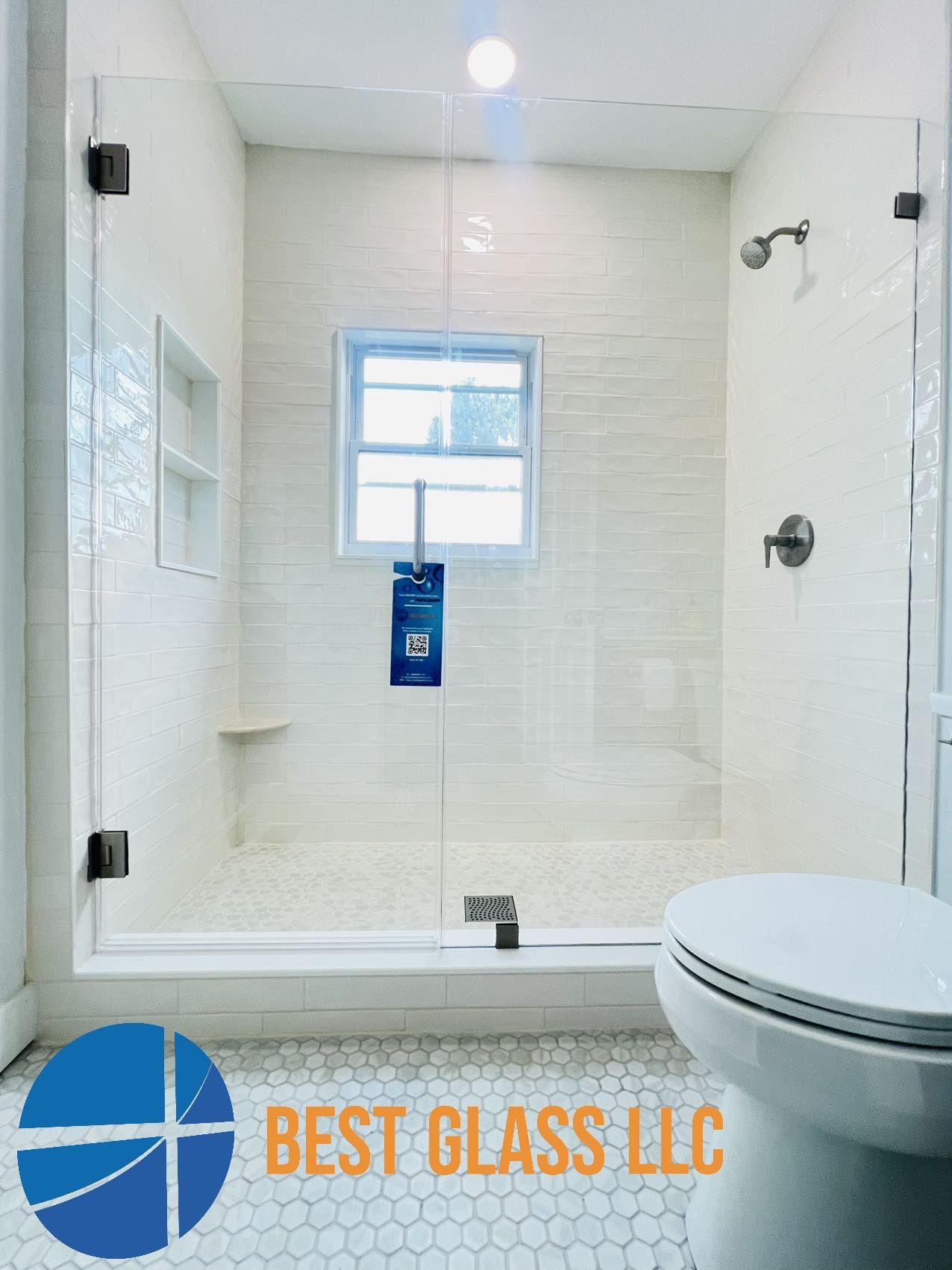 A bathroom with a toilet , shower and window.