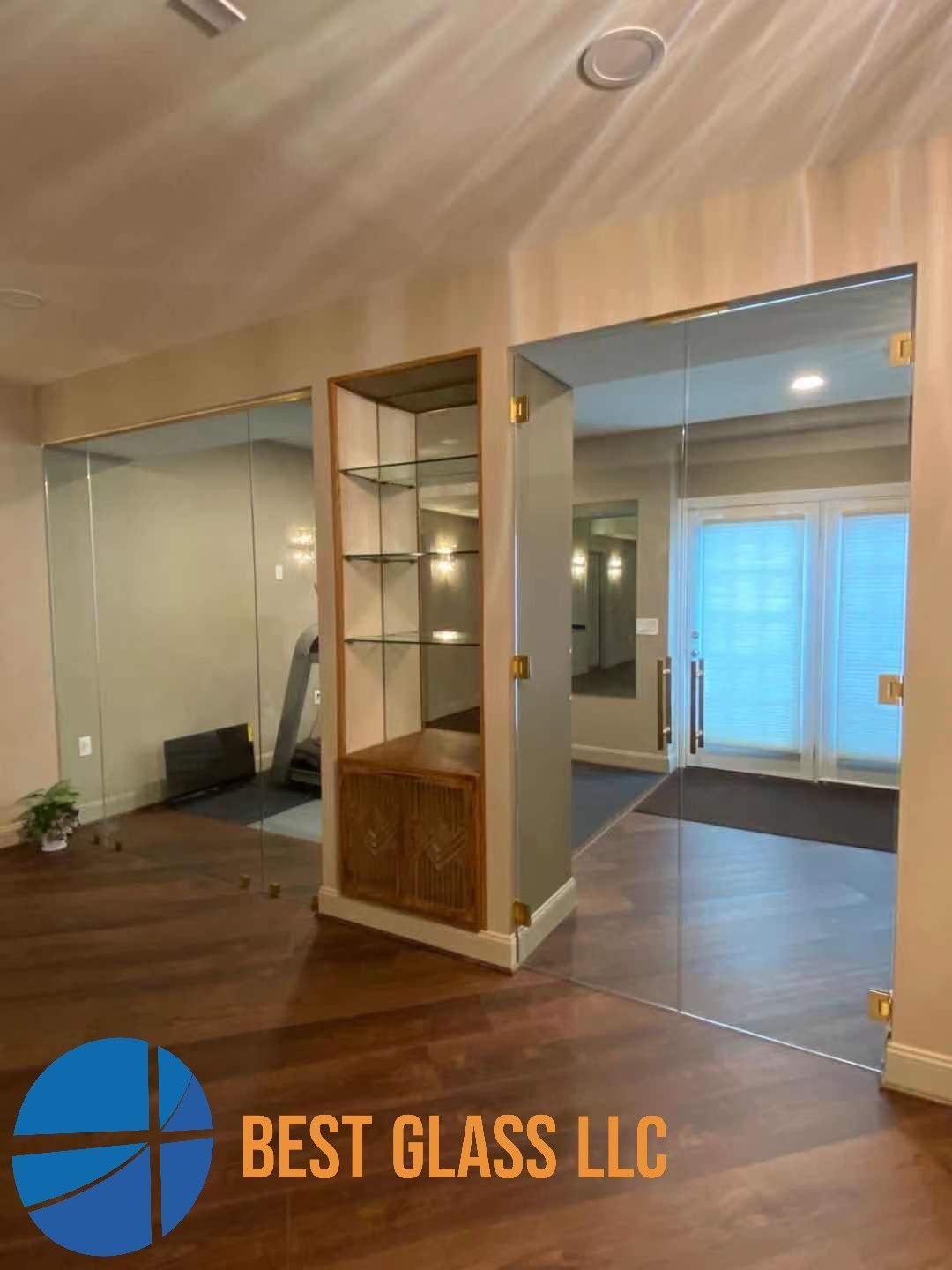 A room with a sign that says best glass llc on it