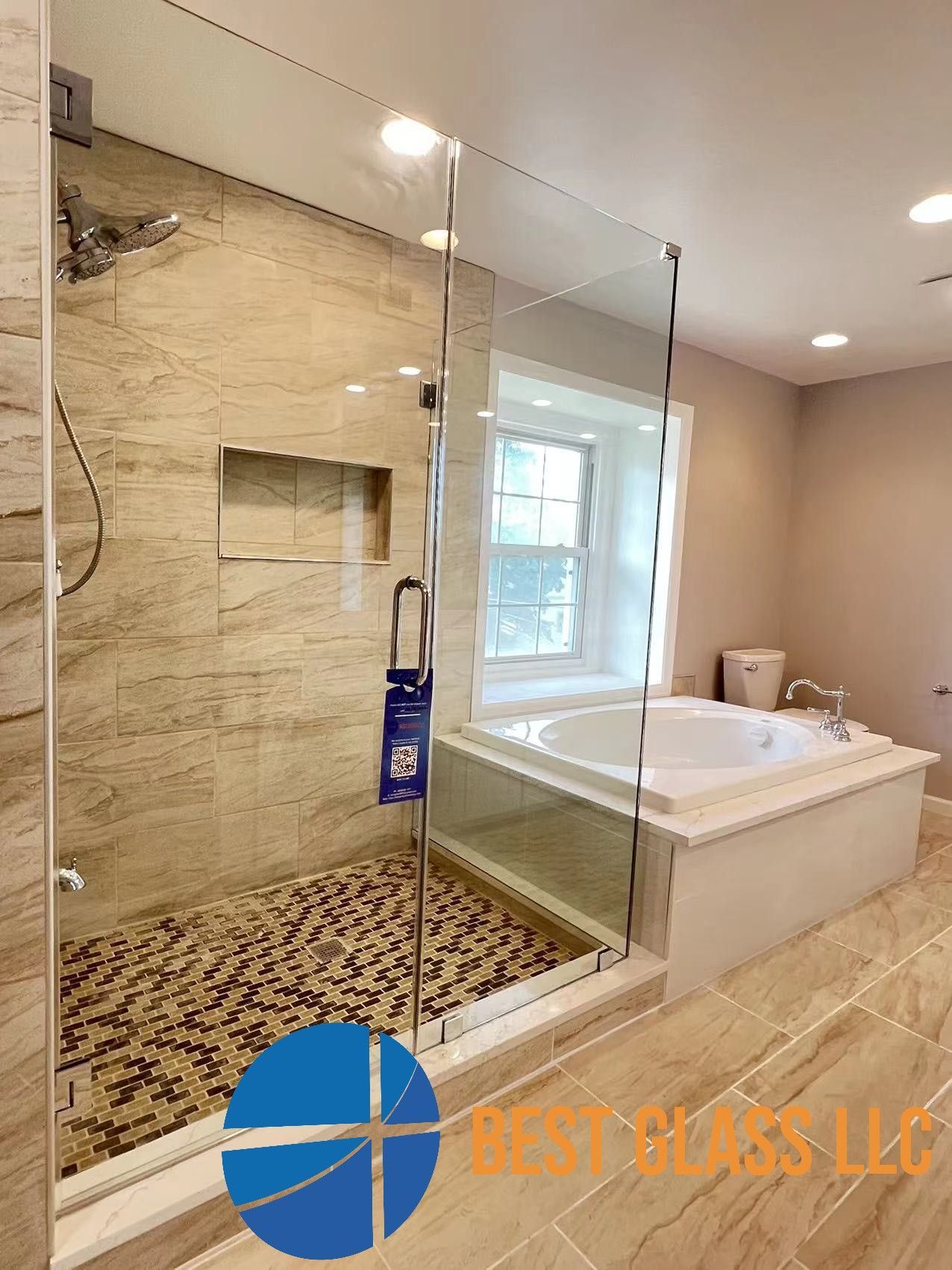 A bathroom with a walk in shower and a bathtub.