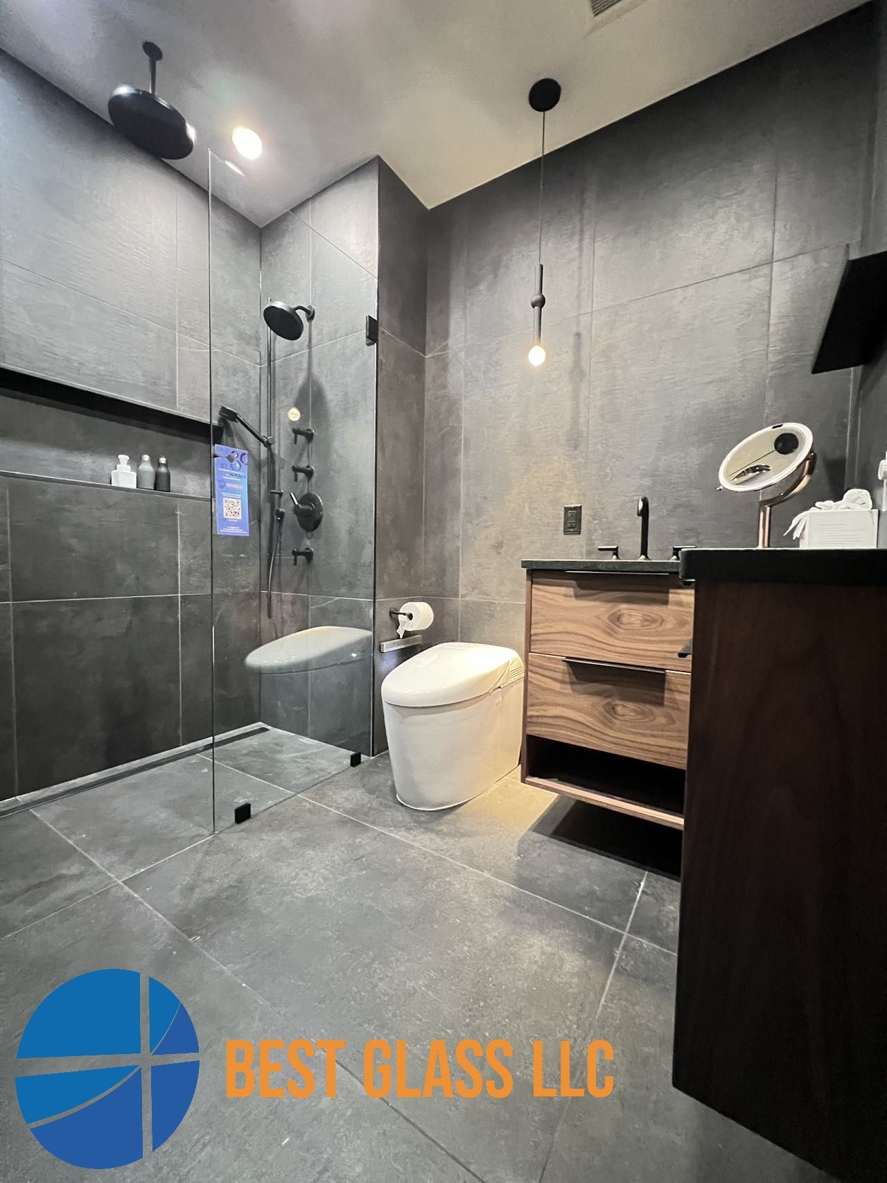 A bathroom with a toilet , sink and shower.