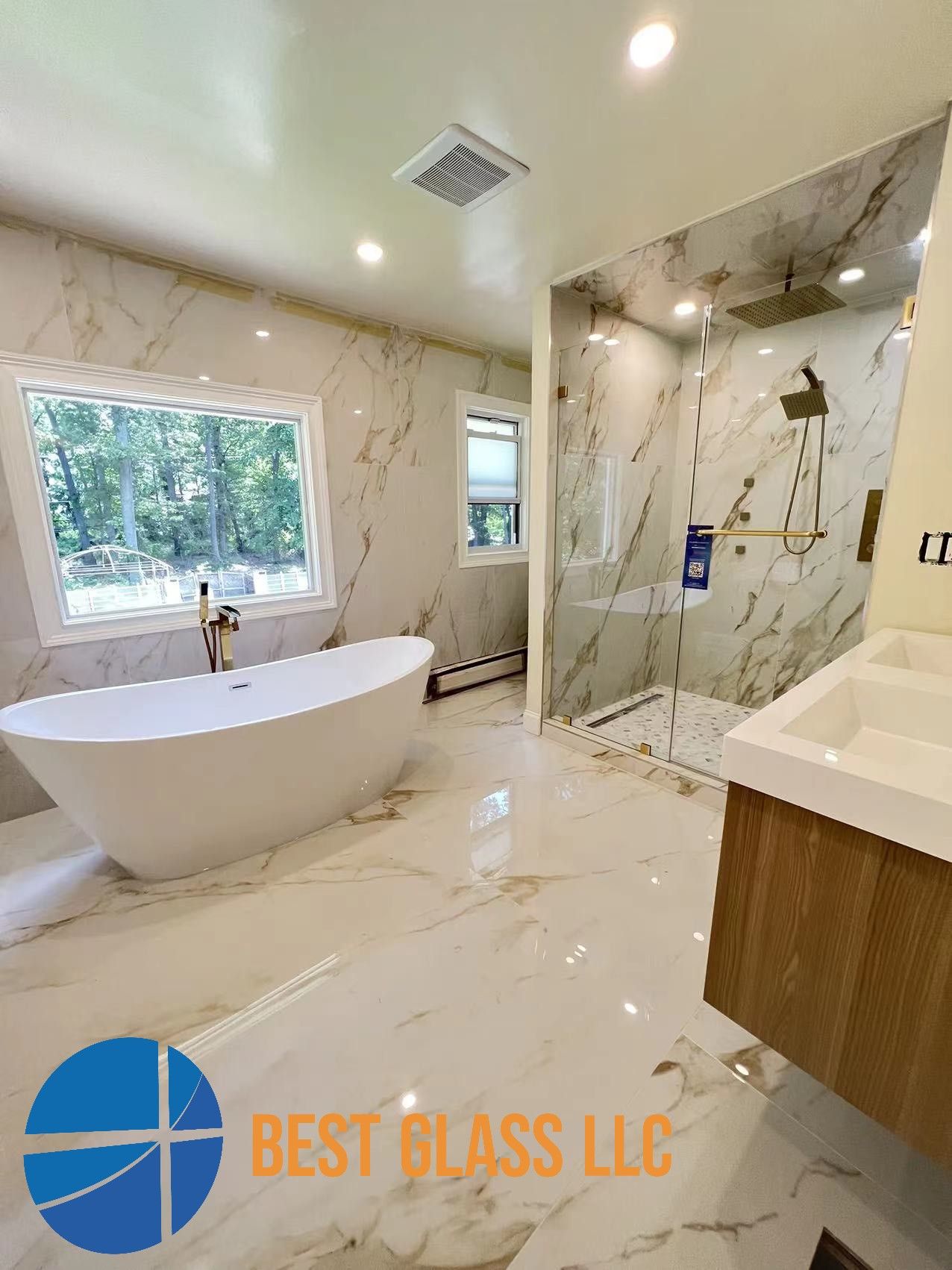 A bathroom with a bathtub , sink , shower and window.