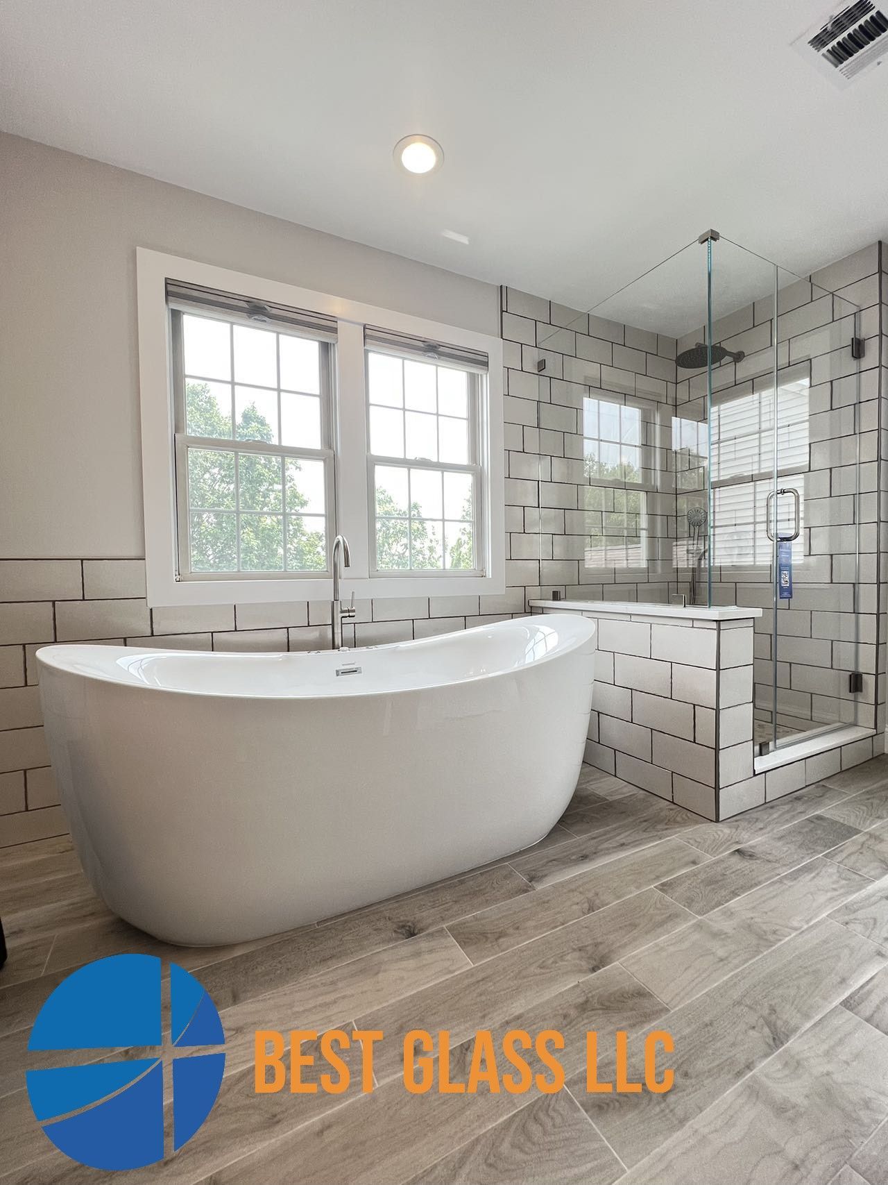 A bathroom with a bathtub and a shower.