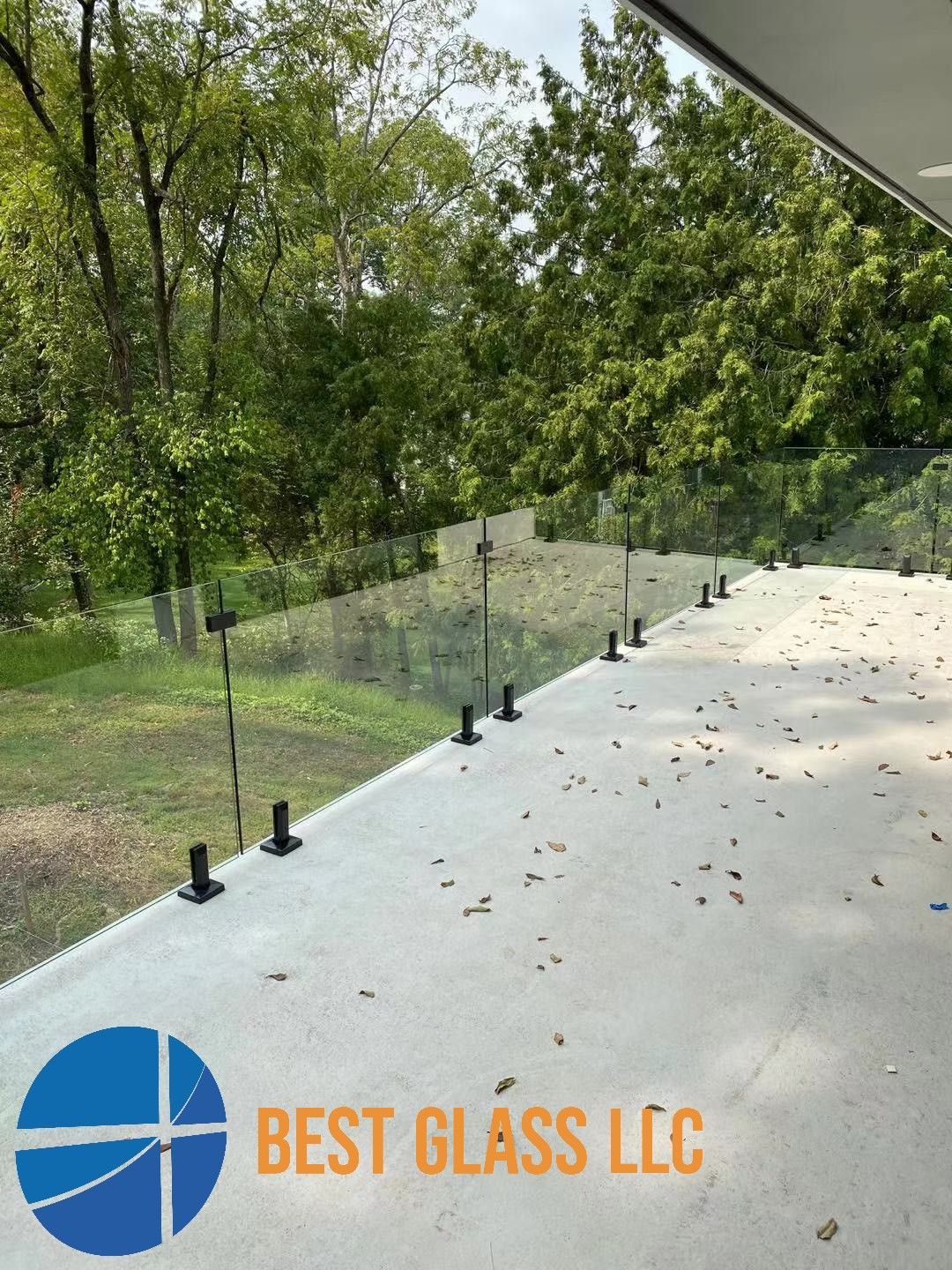 A picture of a balcony with a glass railing from best glass llc