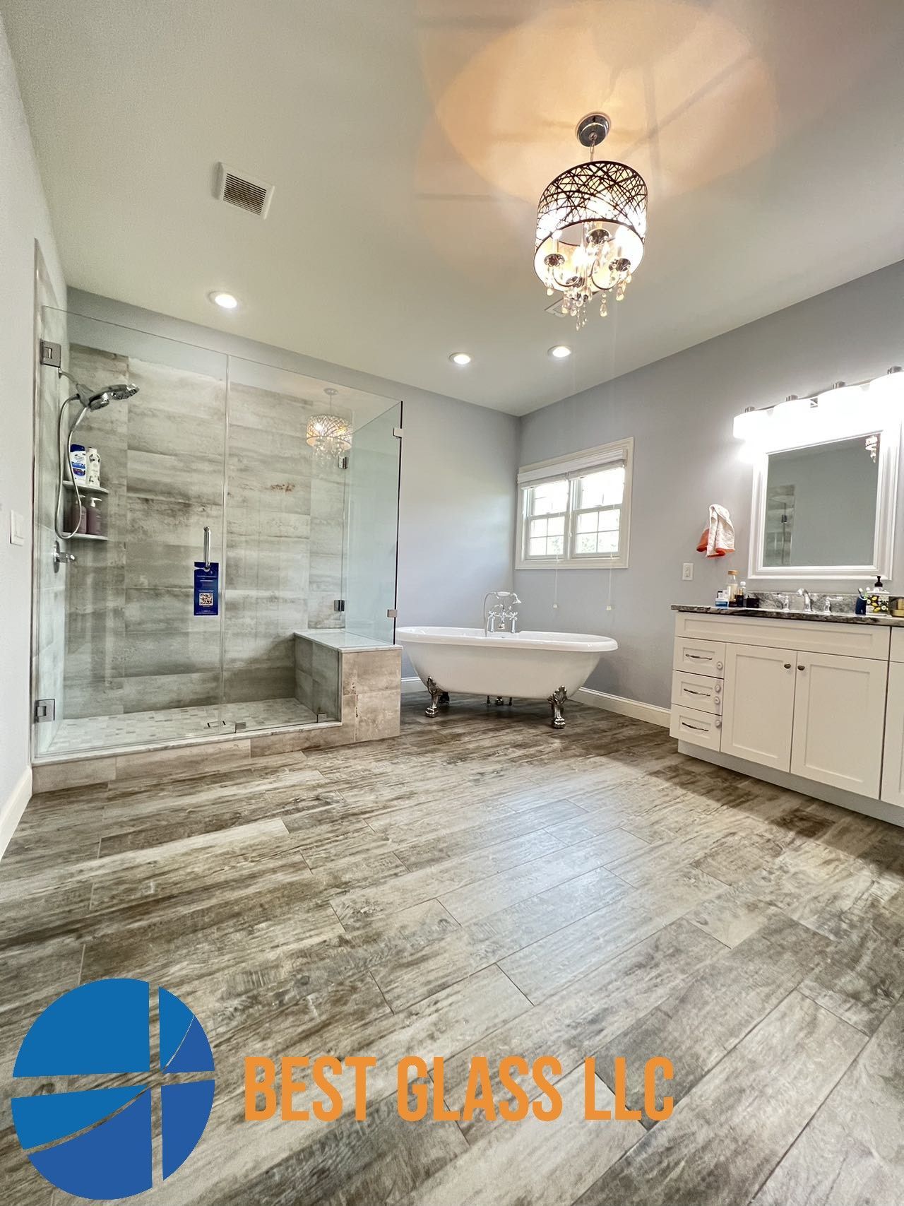 A bathroom with a bathtub and a walk in shower.