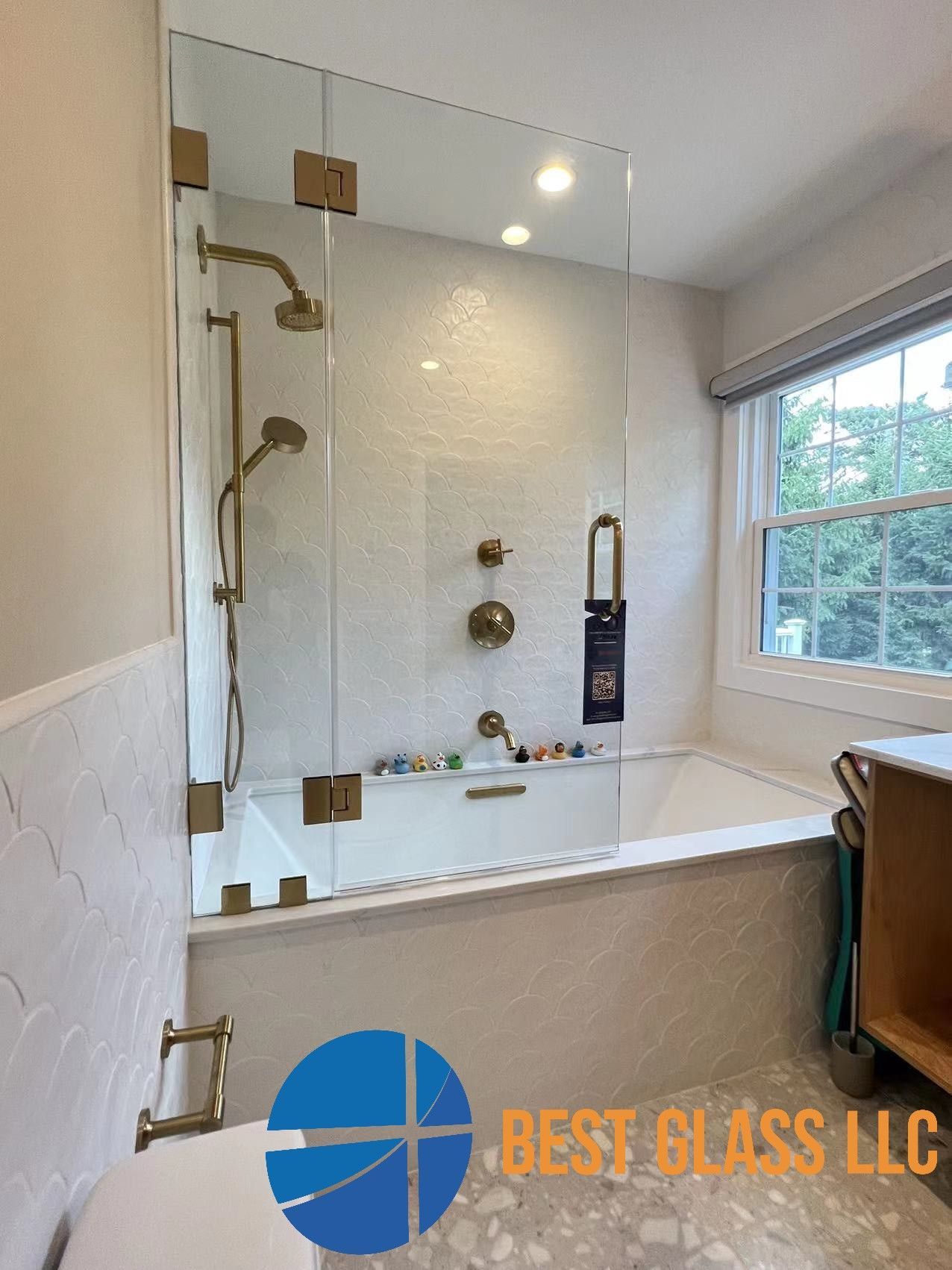 A bathroom with a bathtub , shower , and window.